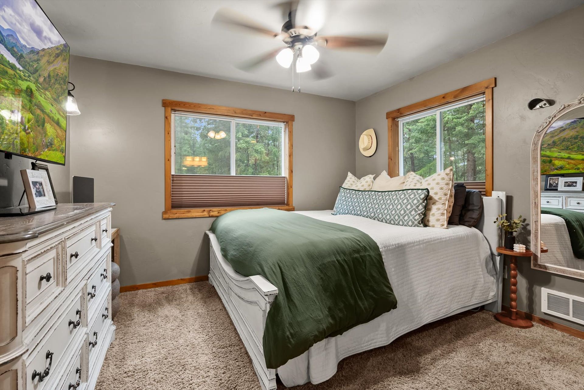 A peaceful retreat: The primary suite features serene forested views, generous natural light, and an ensuite bath, offering a quiet escape.