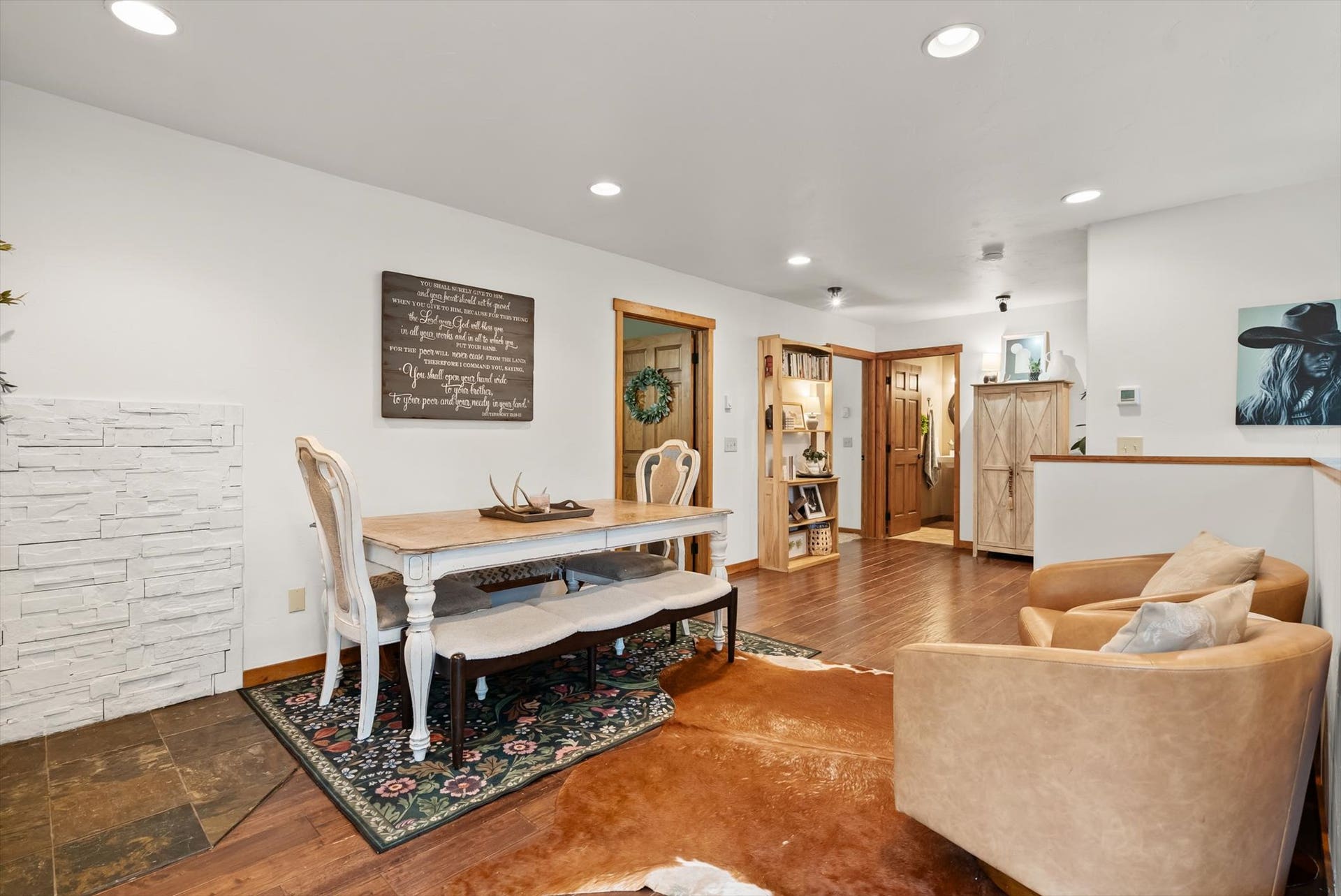Dining area with glass doors leading to deck overlooking forest and meadow views in Kalispell, MT.