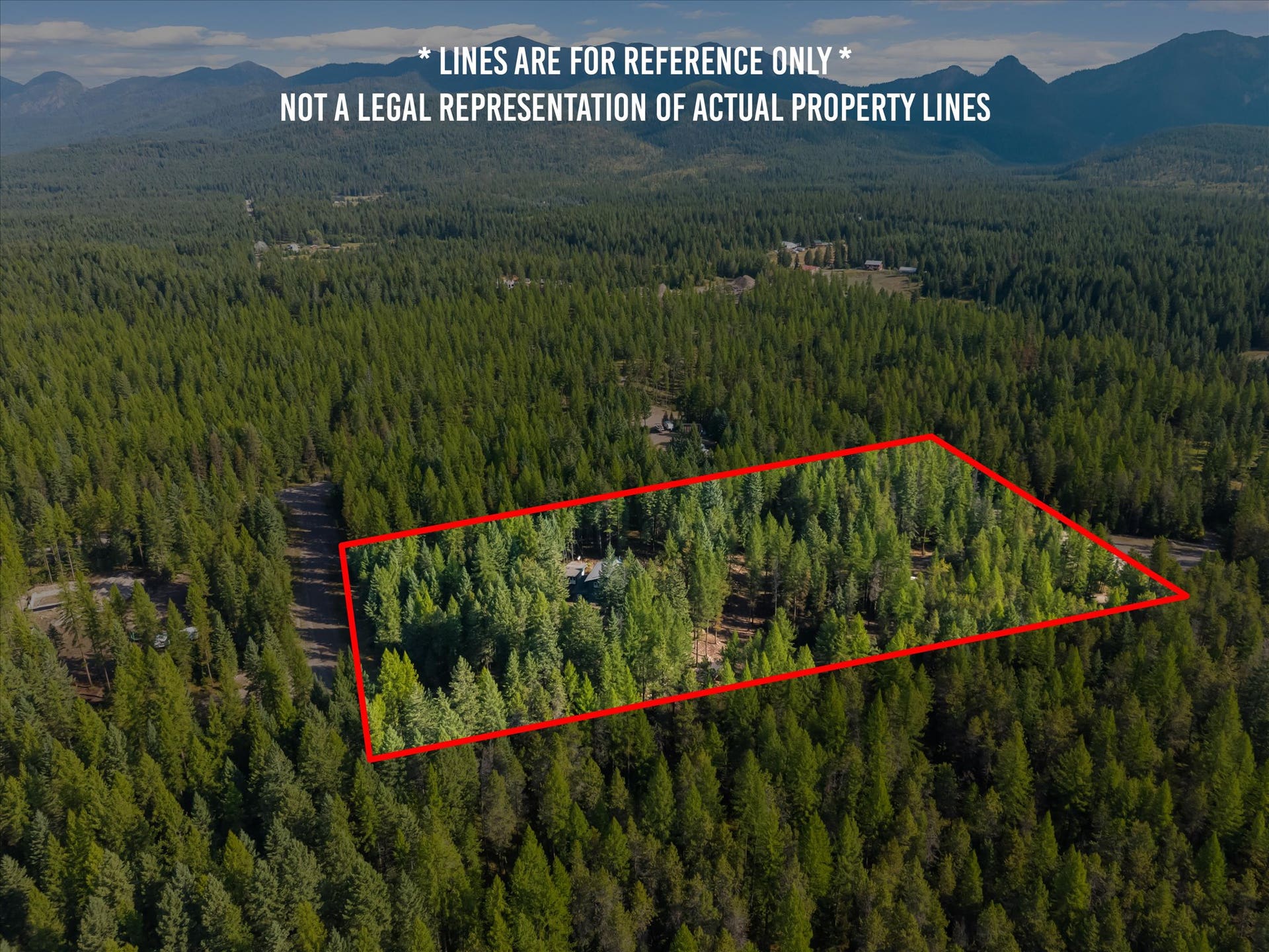 An outdoor enthusiast's paradise: Aerial view highlighting the private 4.79-acre property positioned directly along the Foothills Road corridor. Step out your front door to immediate access for summer hiking, mountain biking, and horseback riding, or explore nearby winter trails perfect for cross-country skiing and snowshoeing throughout the Flathead Valley.