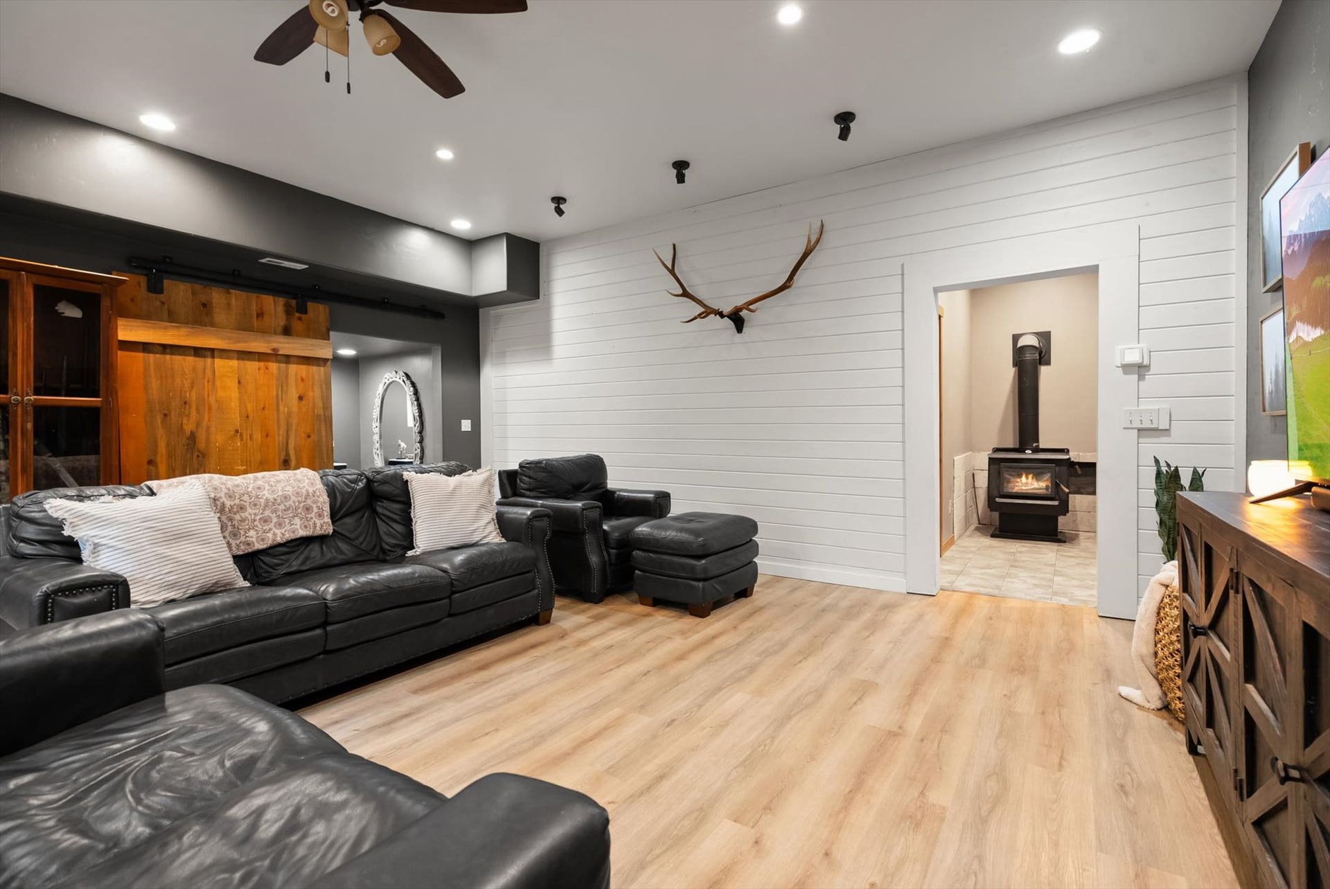 Designed for cozy Montana winters and casual entertaining, the spacious family rec room offers flexible living space with room for game tables, media setups, or a warm wood-stove gathering space.