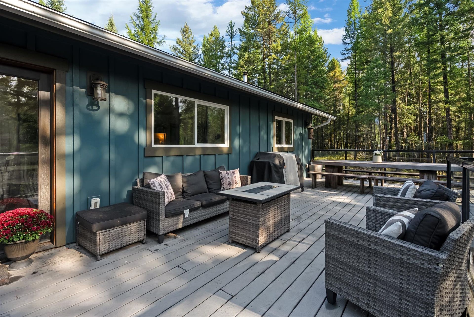 Designed for seamless outdoor living, the expansive deck features sleek glass and metal railings to ensure zero visual barriers between you and your private 4.79-acre estate.