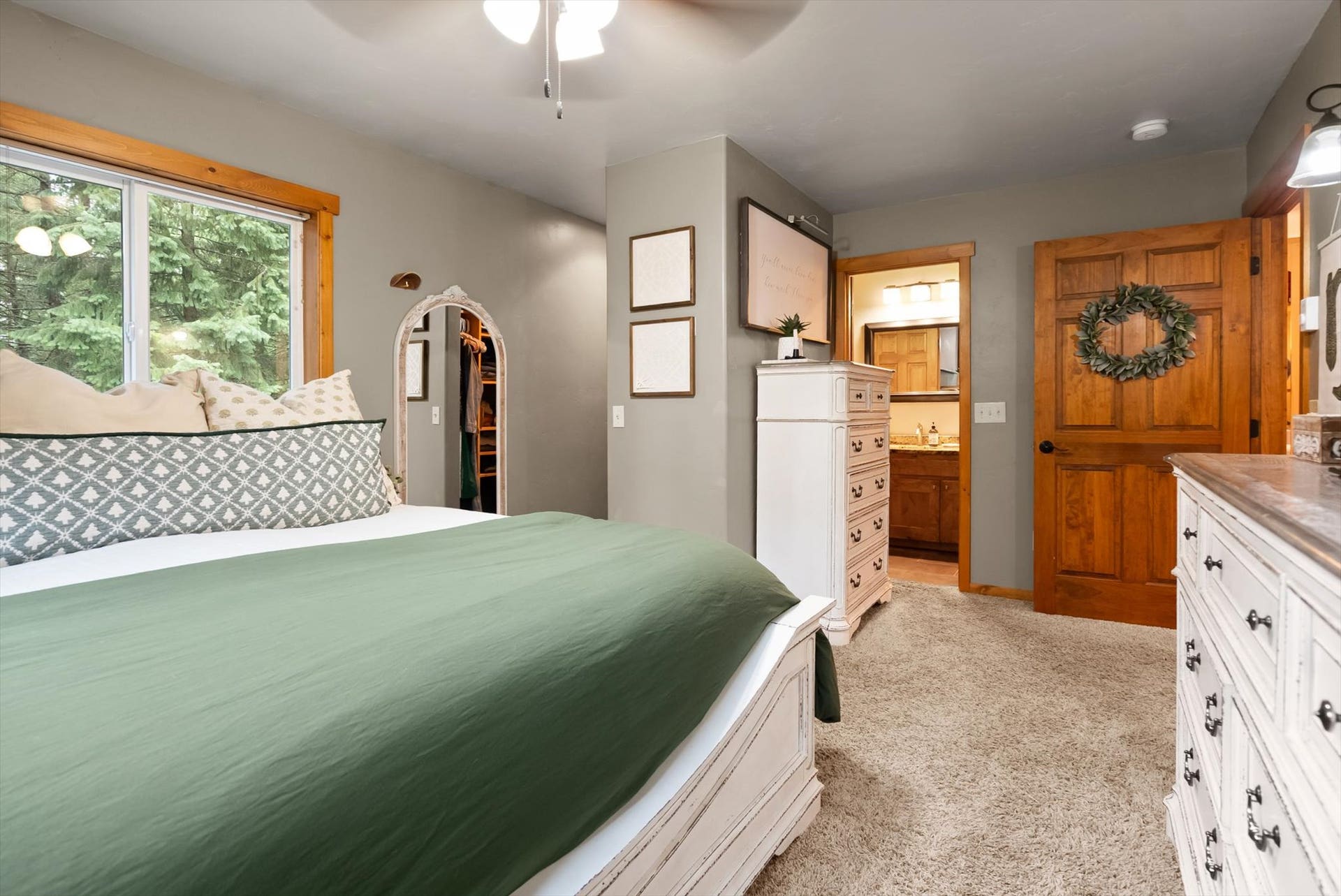 A peaceful retreat: The primary suite features serene forested views, generous natural light, and an ensuite bath, offering a quiet escape.