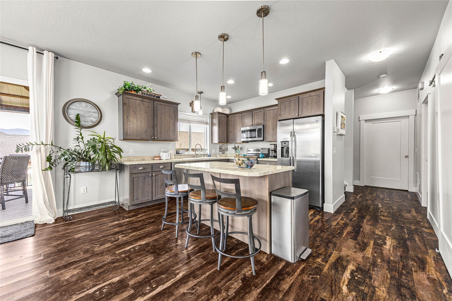 Kitchen featuring wood-finish flooring, recessed lighting, and a center island with pendant lighting