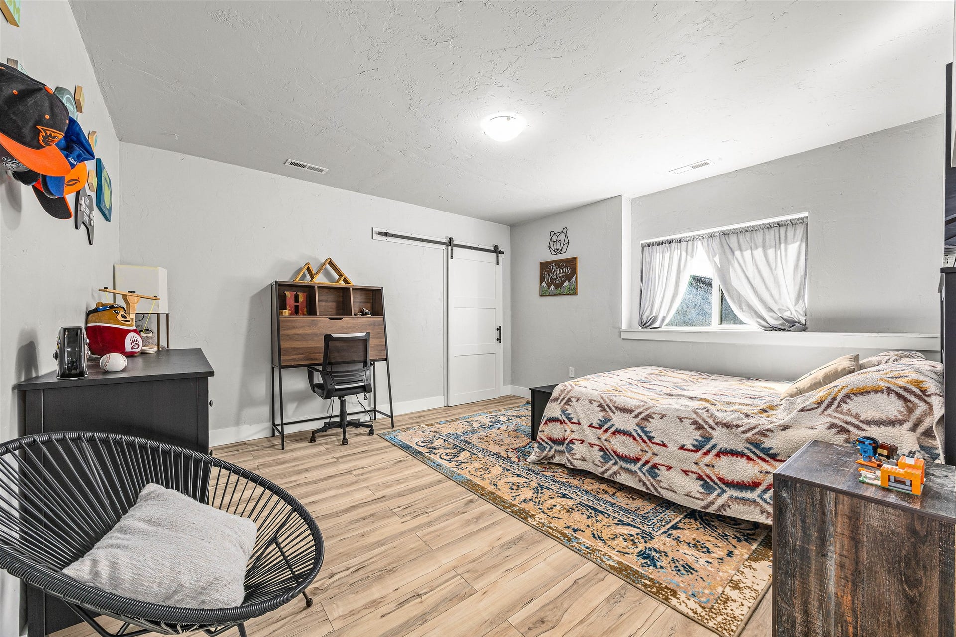 Light wood-finish flooring, recessed window, and white walls