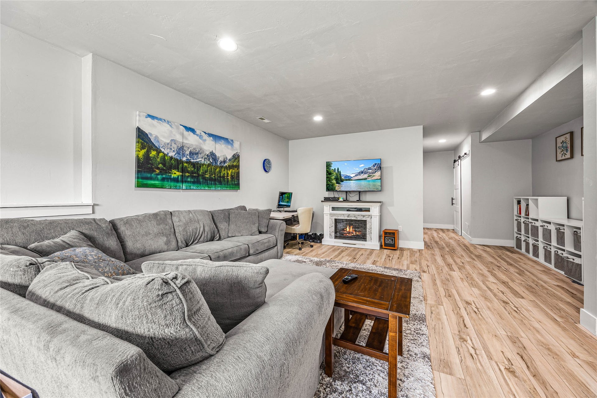 Recessed lighting throughout, wood-finish flooring, and a built-in electric fireplace