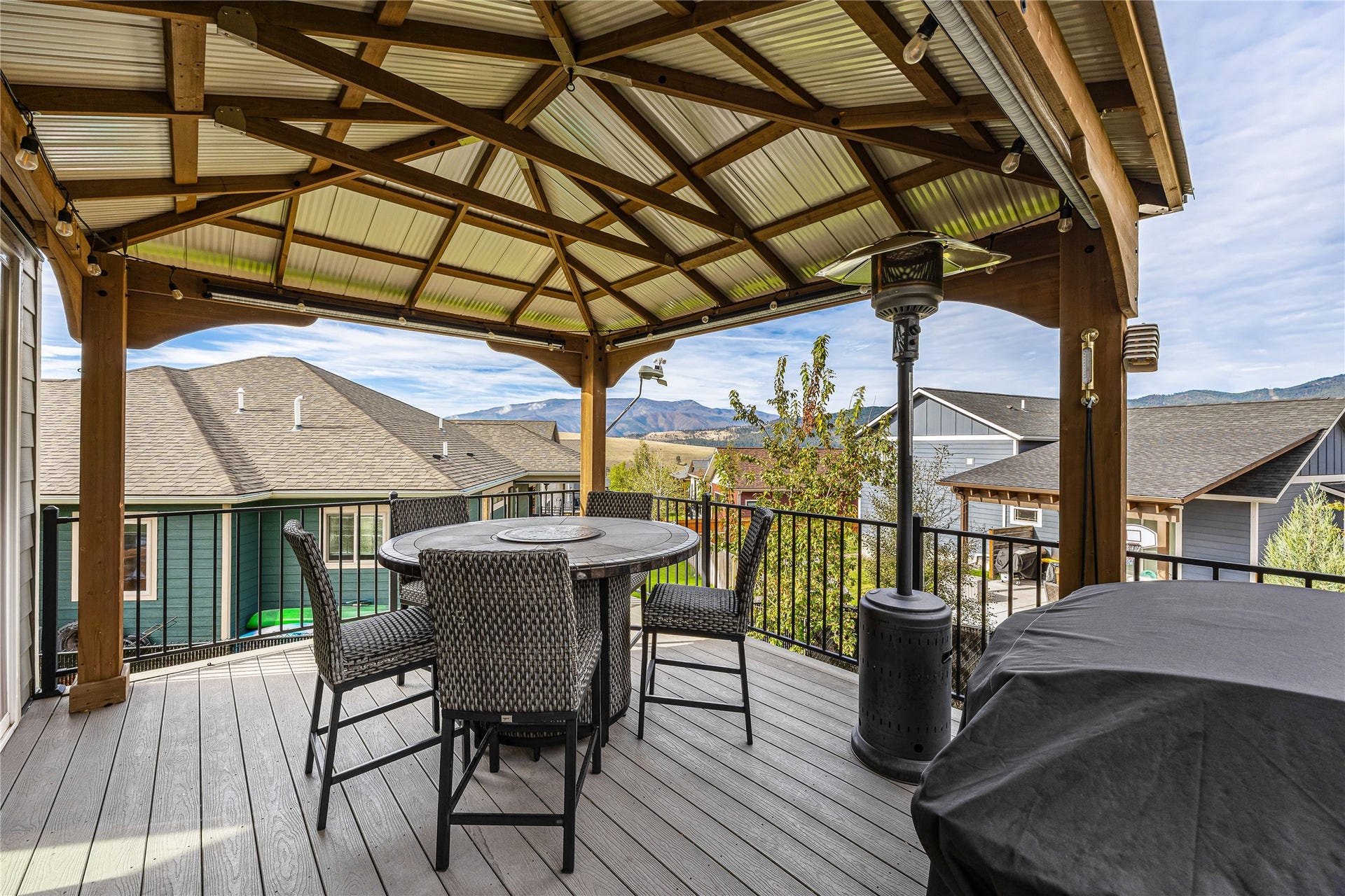 Covered deck featuring a corrugated metal roof and composite decking