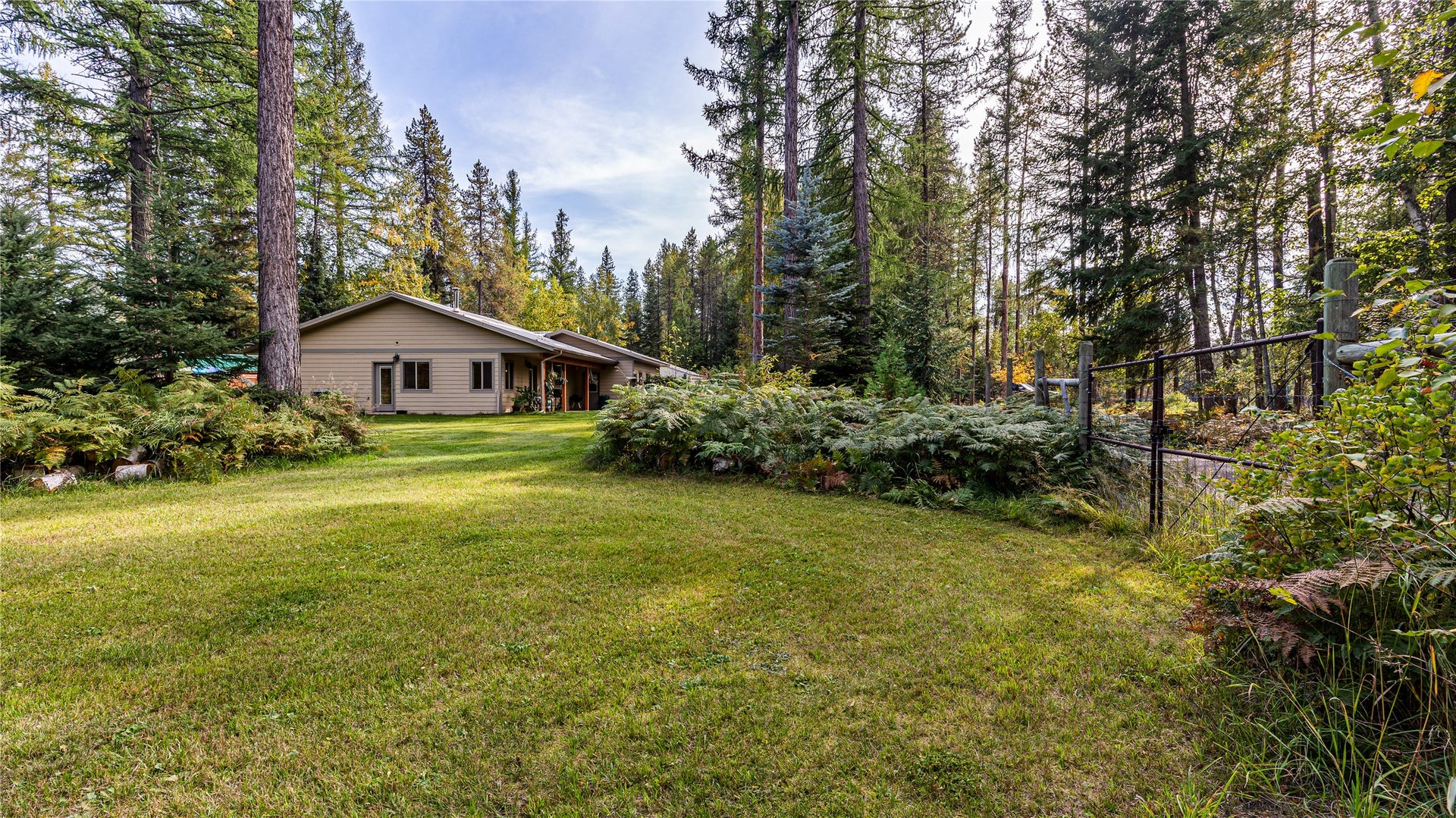 582 Ferndale Drive, Bigfork, MT 59911 Fenced Back Yard surrounded by ferns and foliage