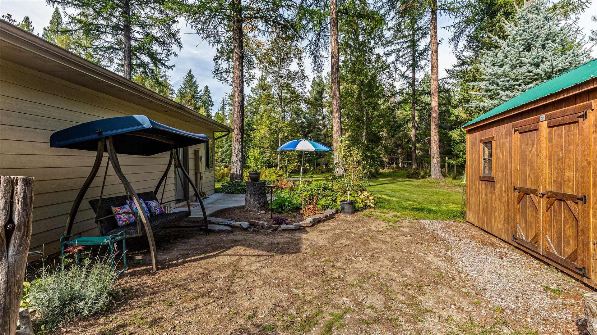 582 Ferndale Drive, Bigfork, MT 59911 Side yard bordering garden and garden shed