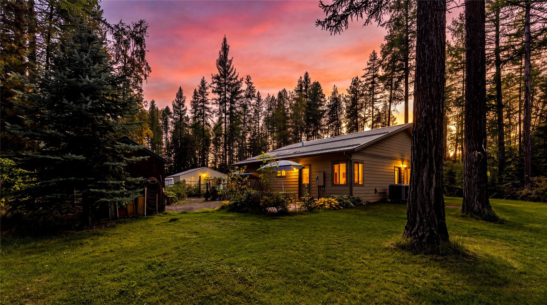 582 Ferndale Drive, Bigfork, MT 59911 Wooded Back Yard overlooking the garden -virtually enhanced sunset