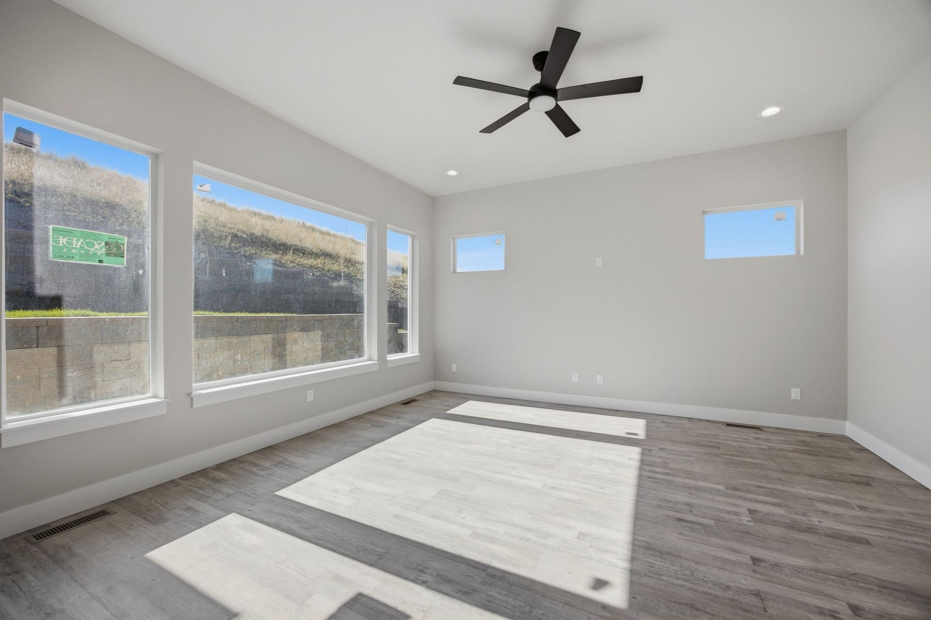 Recessed lighting, wood-finish flooring, ceiling fan, multiple windows