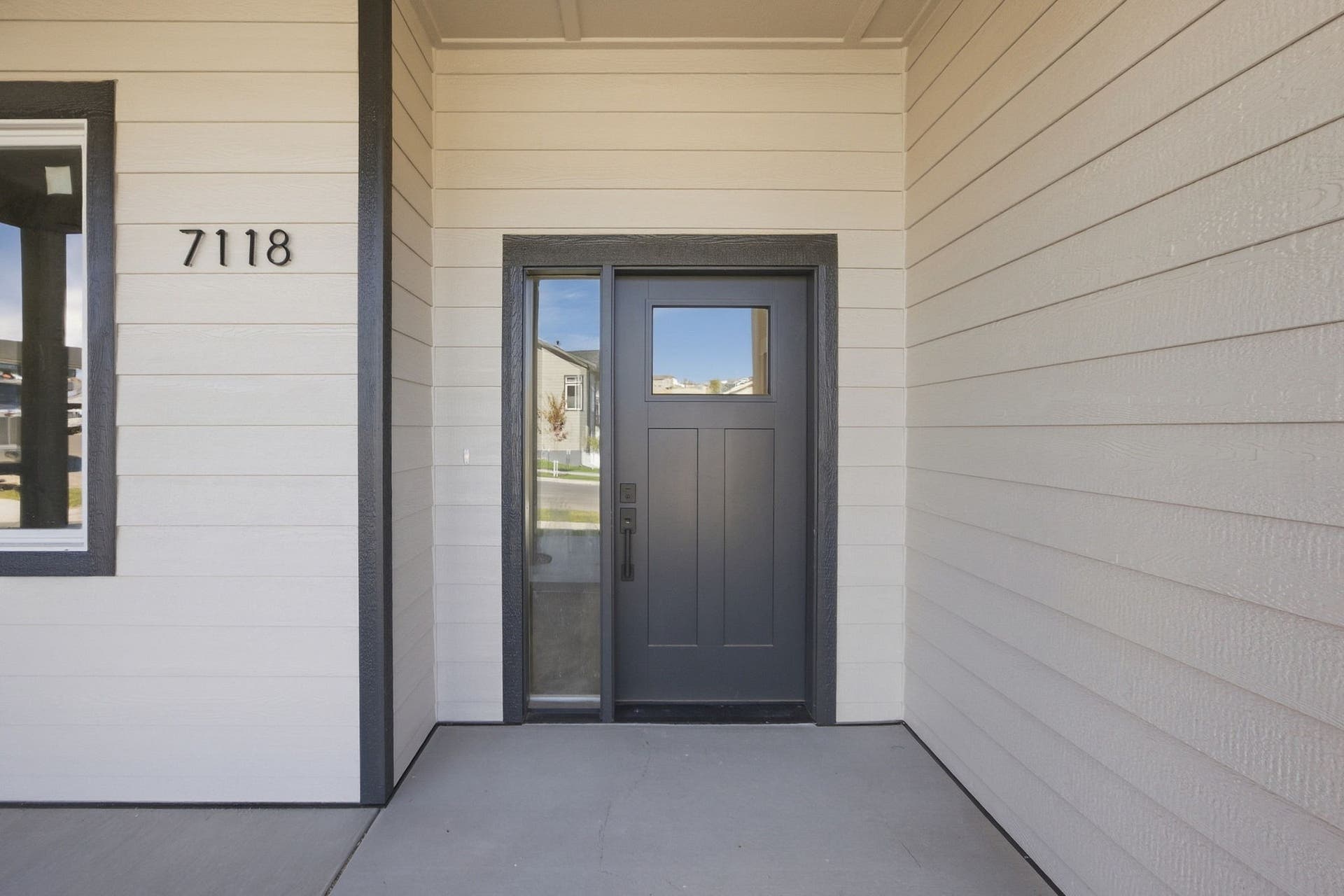 Fiber cement siding with dark trim accents