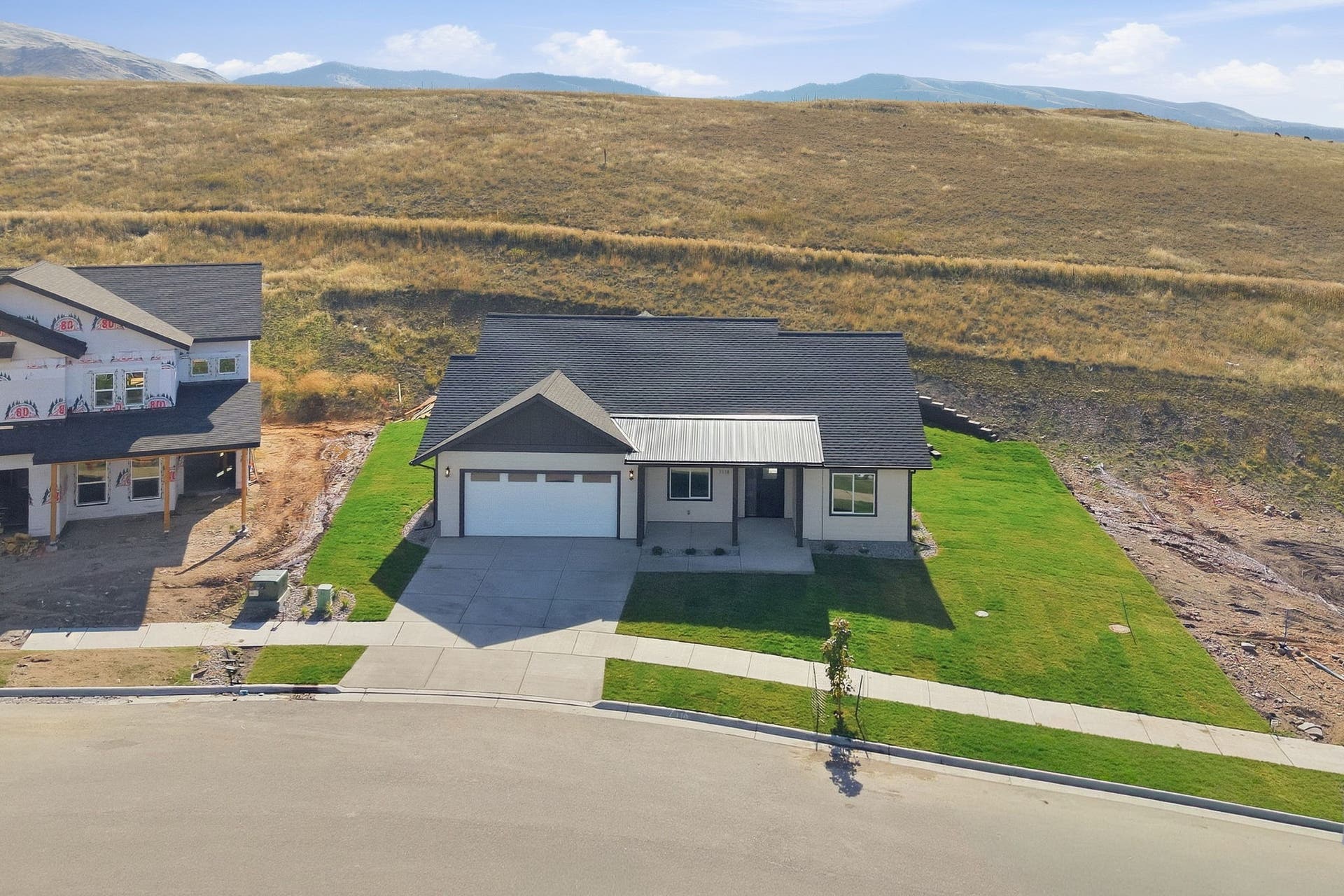 Contemporary single-story residence with a dark asphalt shingle roof