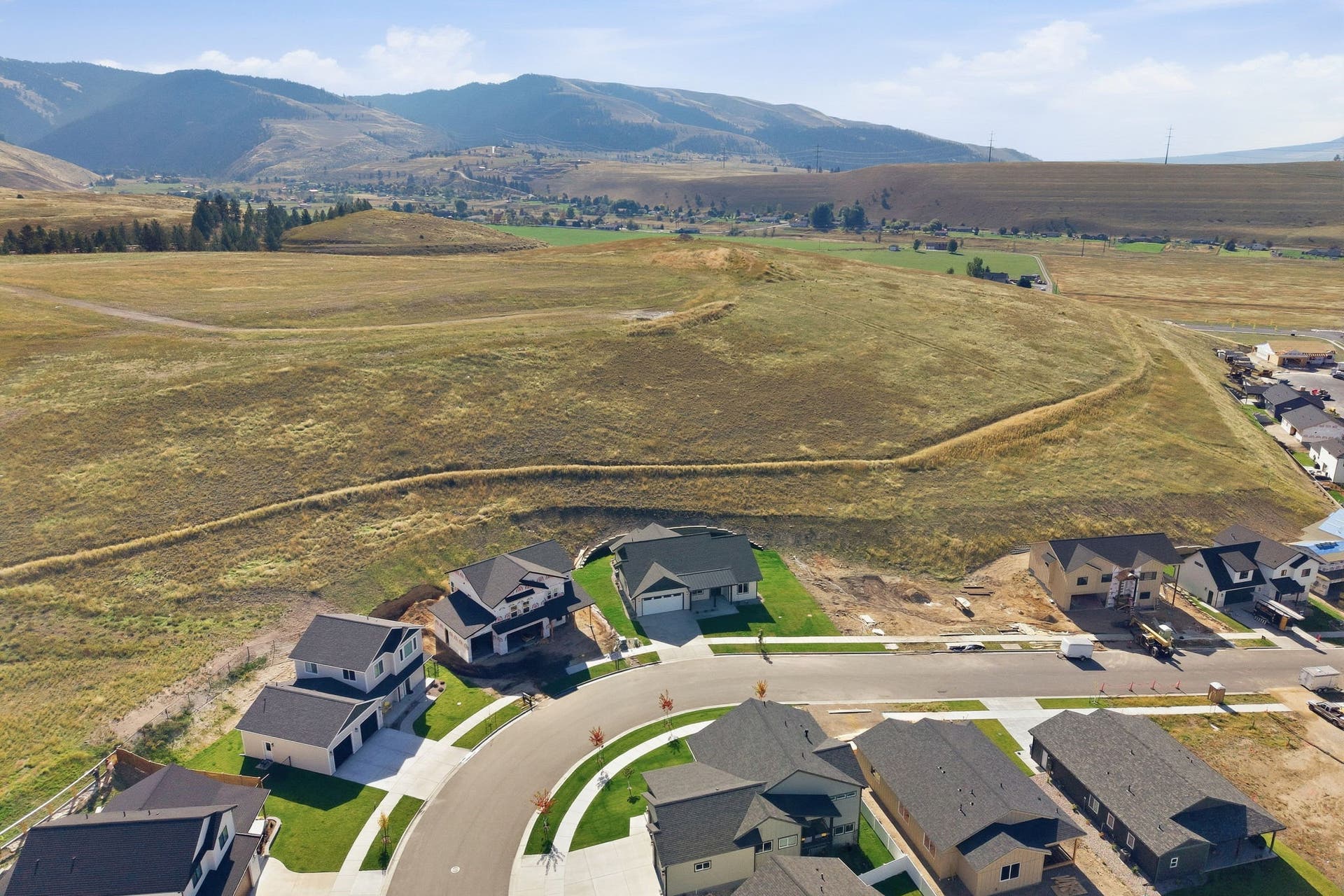 Residential community featuring paved streets, developed home lots, and distant mountain topography