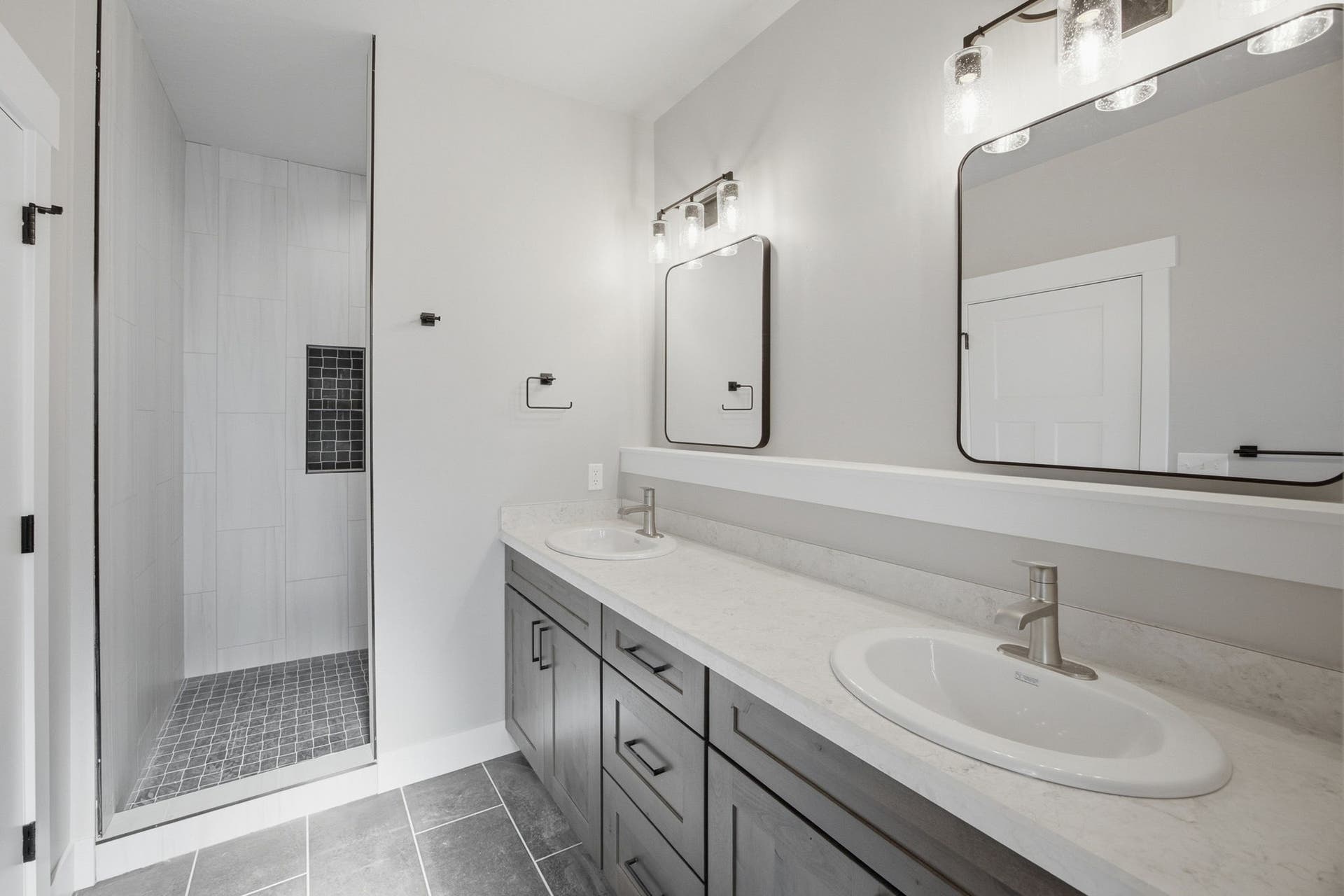 Dual vanity with undermount sinks and light-toned countertops