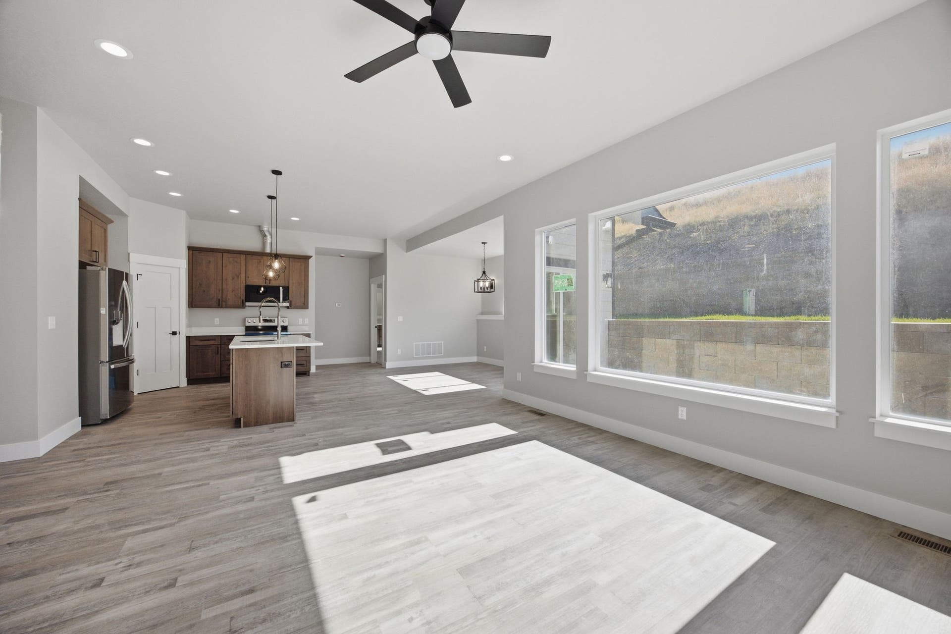 Open concept living area with wood-finish flooring