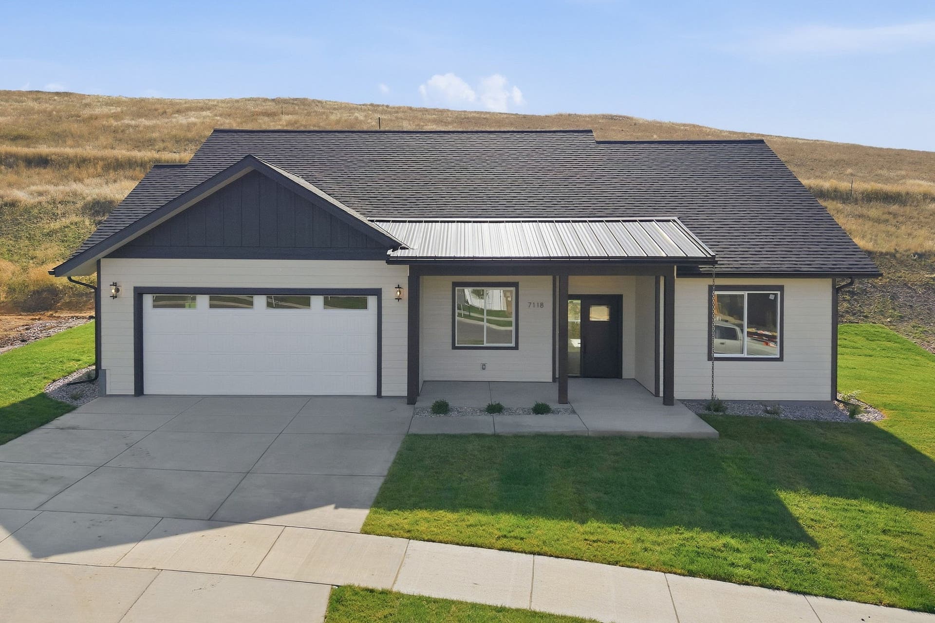 White siding exterior with dark trim accents