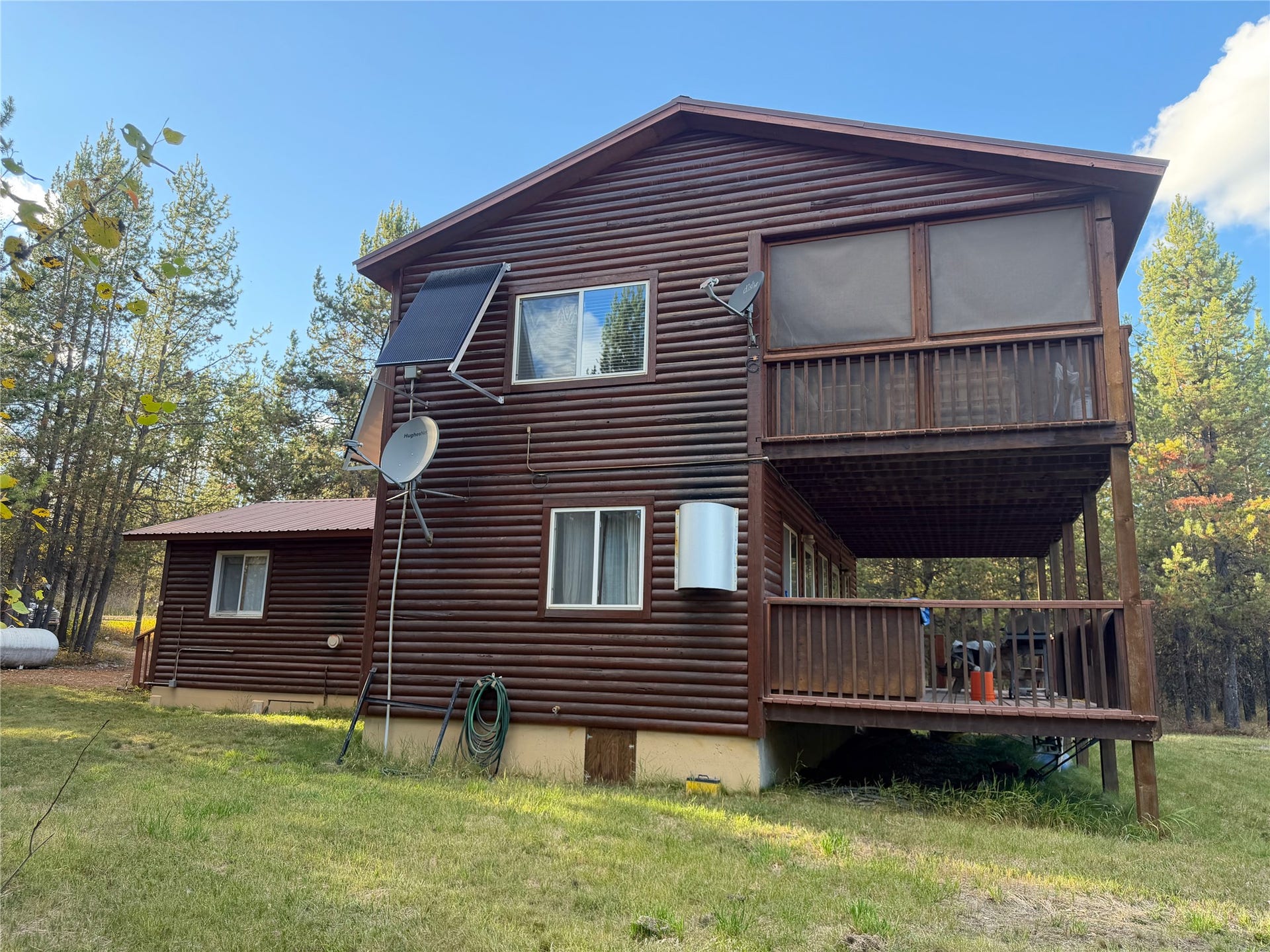 10601 North Fork Road, Polebridge, MT 59928 Side with Solar Panels & Satellite Dish