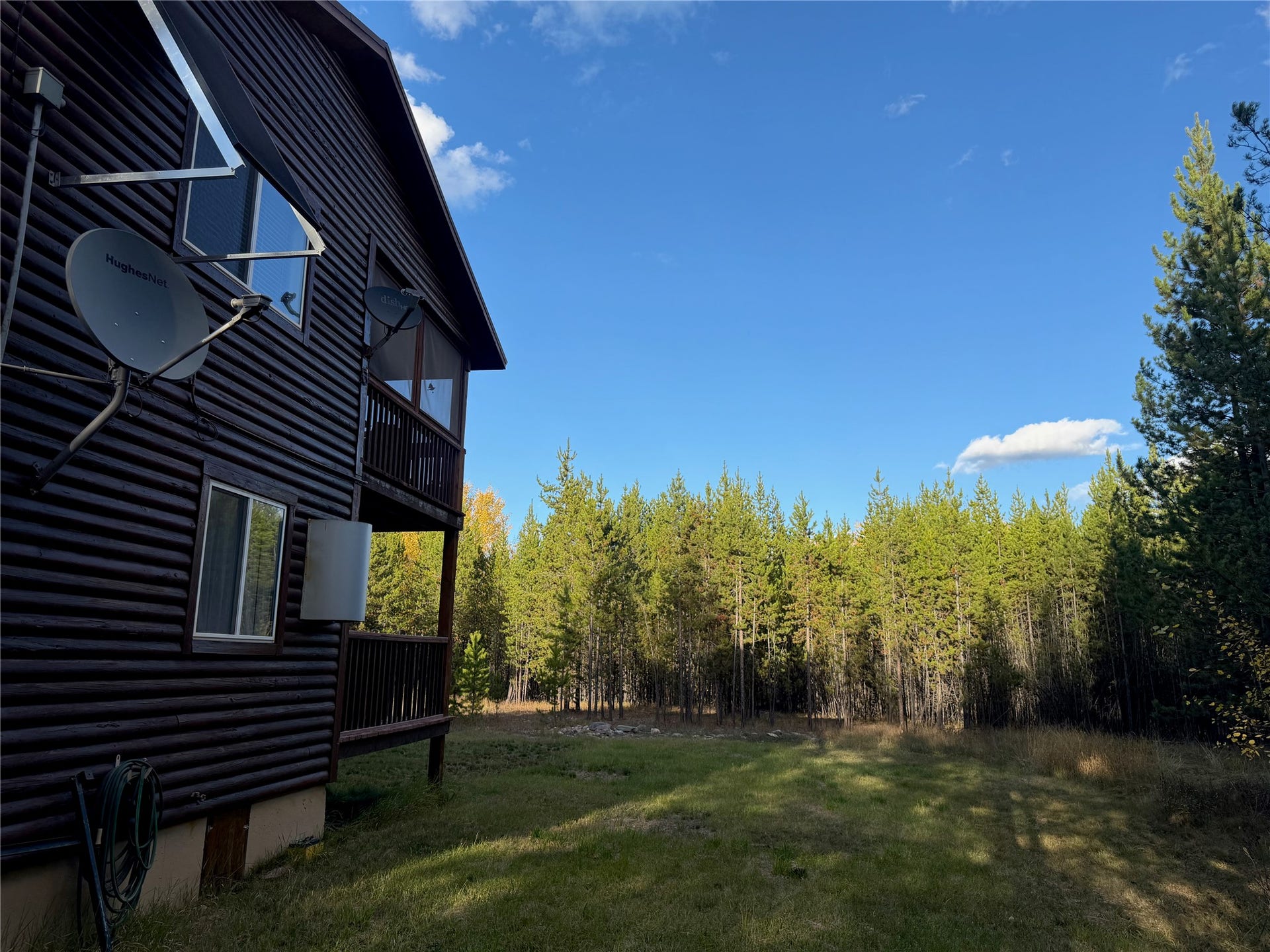 10601 North Fork Road, Polebridge, MT 59928 Side with Solar Panels & Satellite Dish