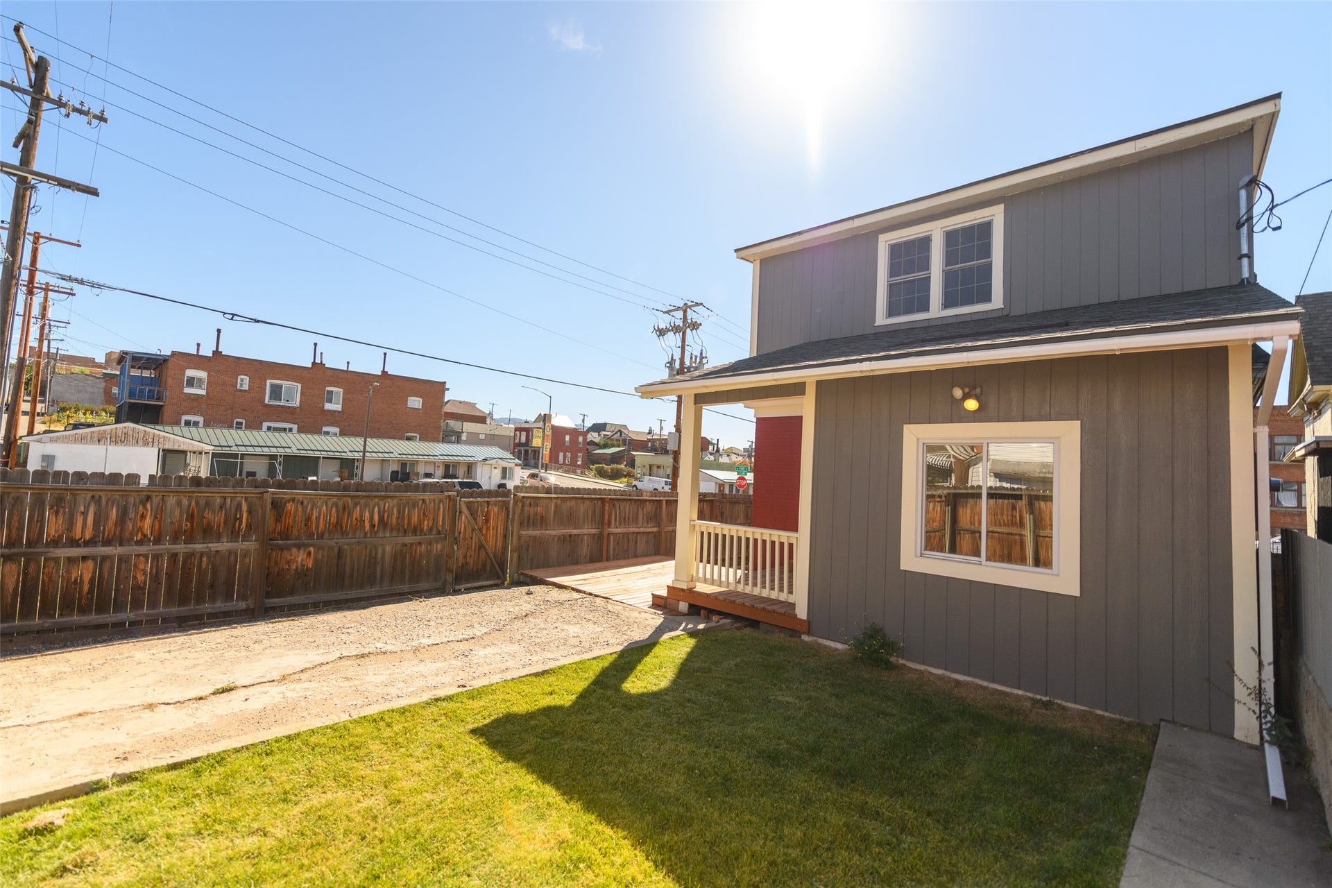 705 W Park Street, Butte, MT 59701 Gray siding exterior with white trim, covered porch, wood plank deck, and a fenced yard