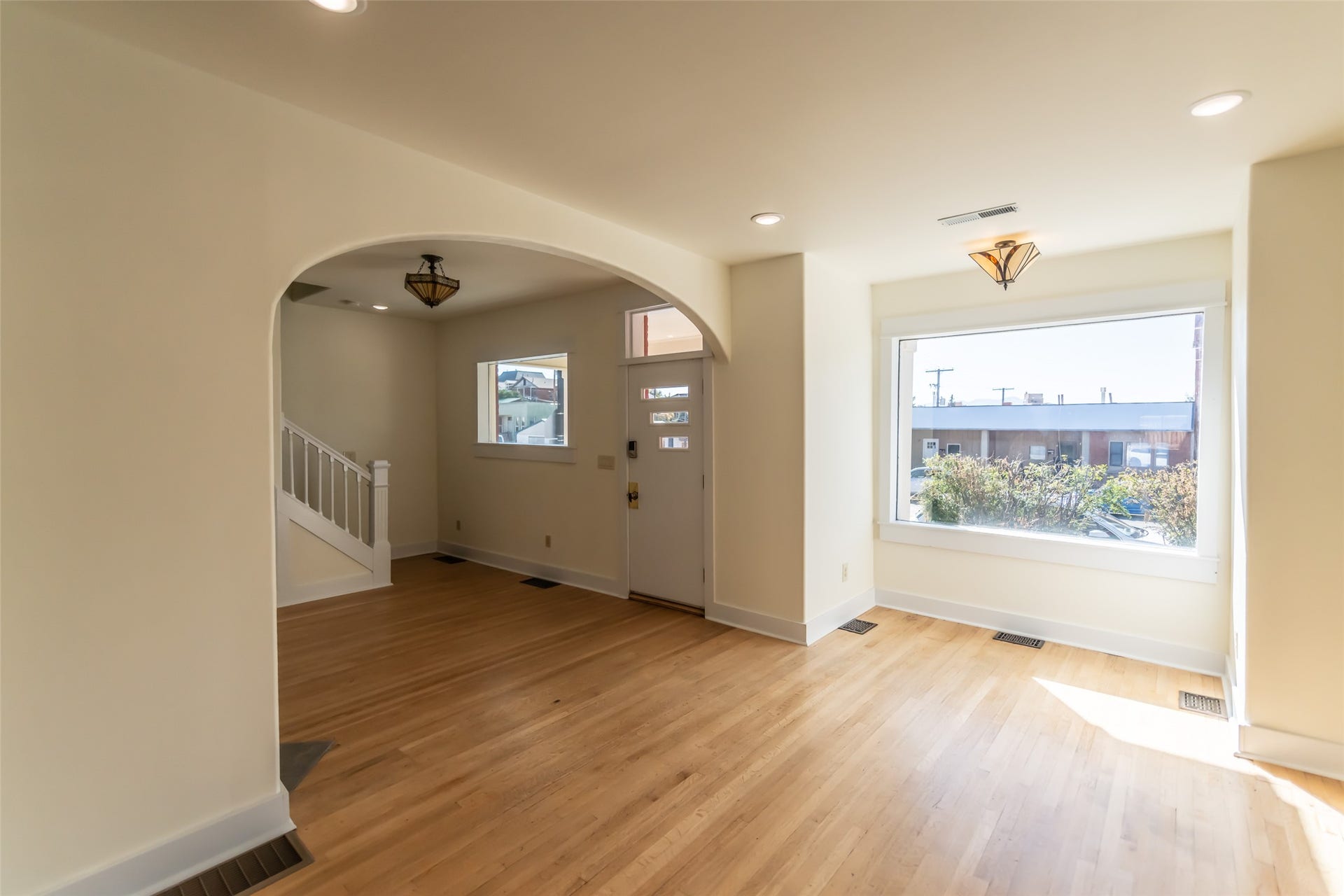 705 W Park Street, Butte, MT 59701 Hardwood flooring, recessed ceiling lighting, a large picture window, and an arched entry