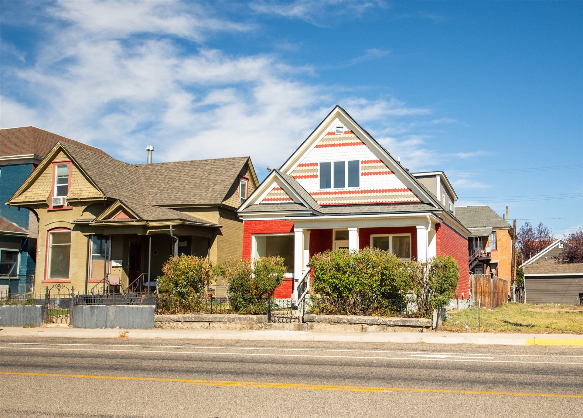 705 W Park Street, Butte, MT 59701 Red brick exterior with white trim, a covered porch with white columns, and an upper-level window with decorative siding