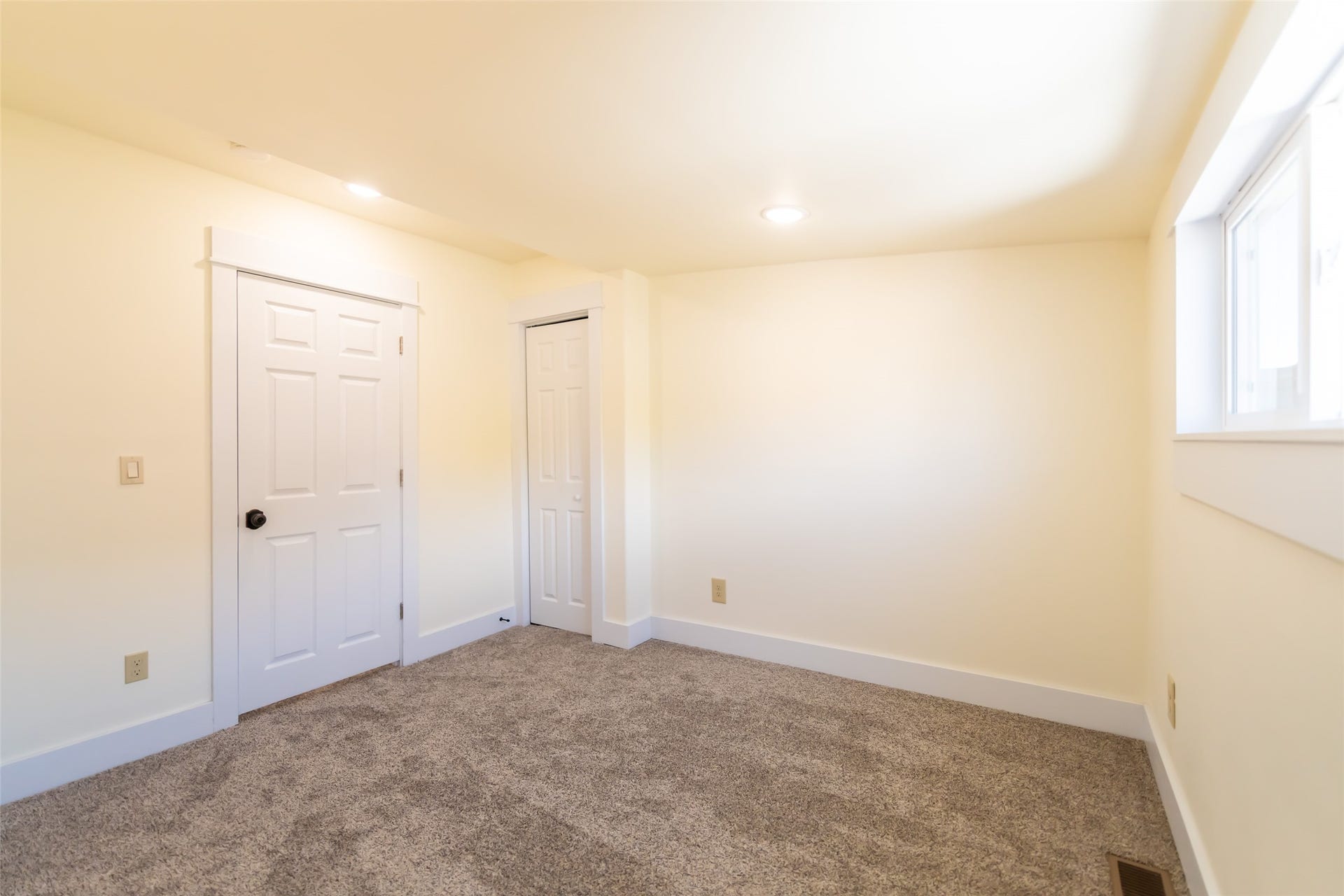 705 W Park Street, Butte, MT 59701 Wall-to-wall carpeting, window with a white frame, two white paneled doors, and recessed ceiling lighting