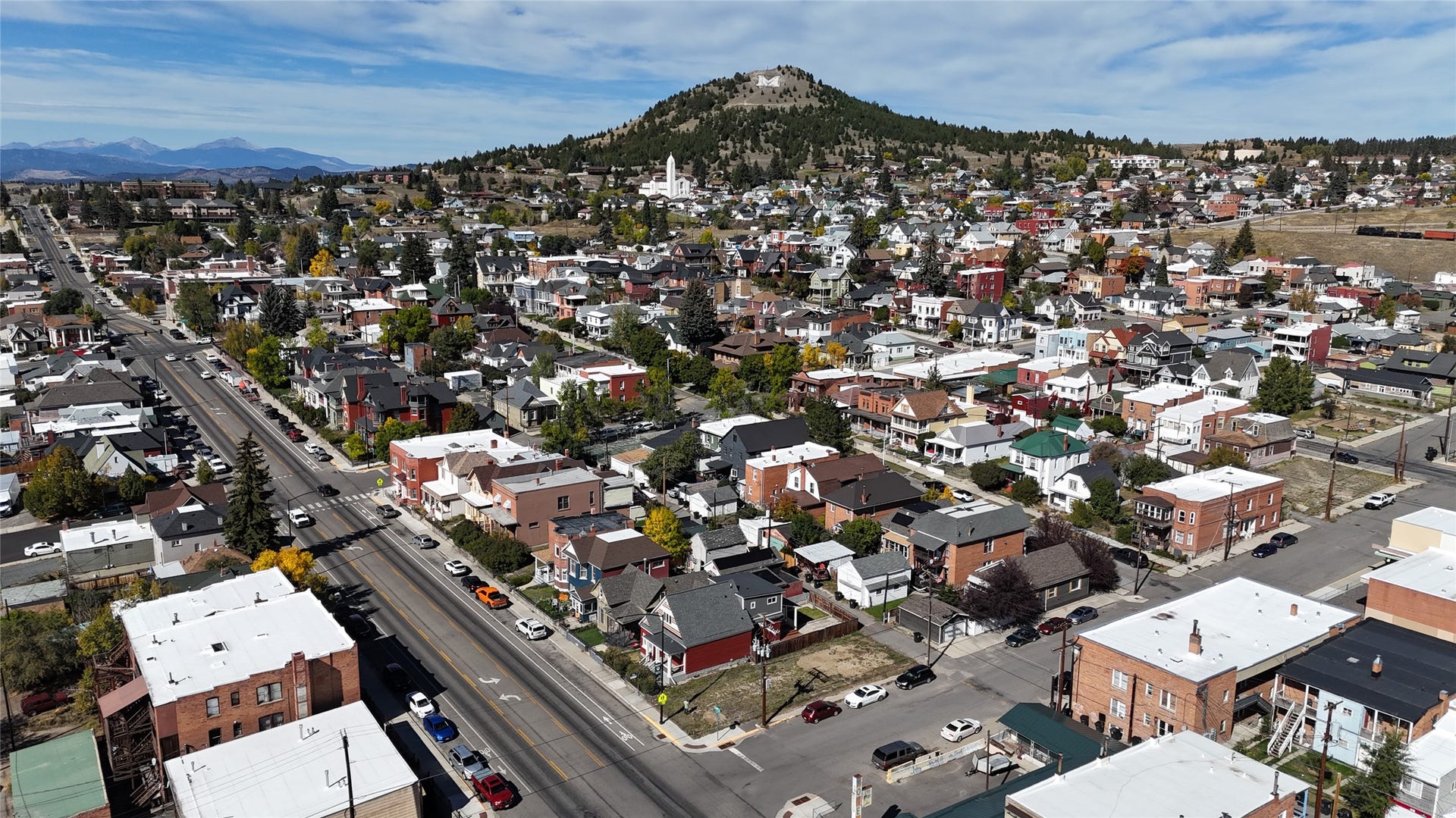 705 W Park Street, Butte, MT 59701 Residential street with multiple properties and a distant mountain range