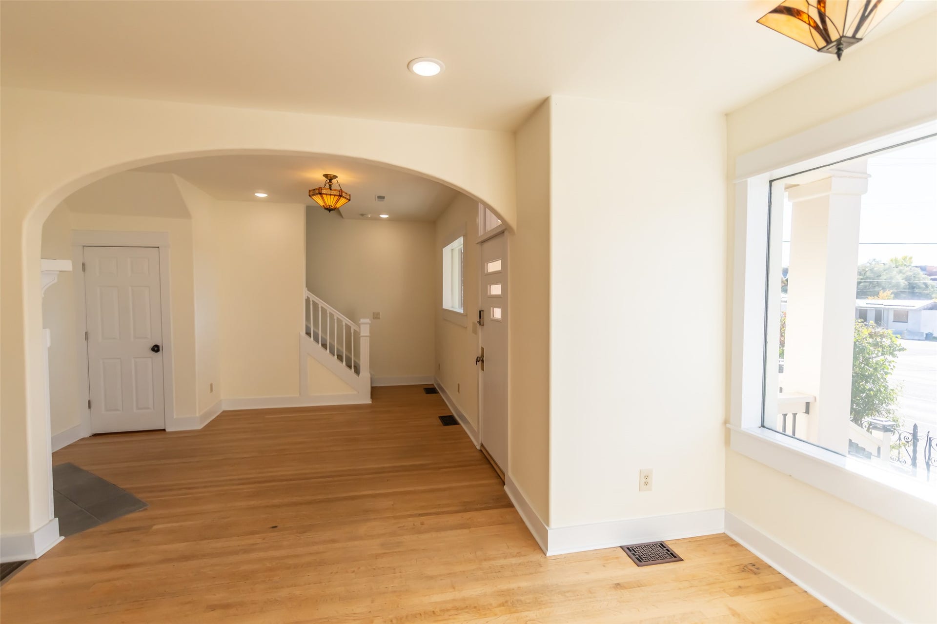 705 W Park Street, Butte, MT 59701 Hardwood flooring, arched entryway, white trim, recessed lighting, and a decorative ceiling fixture