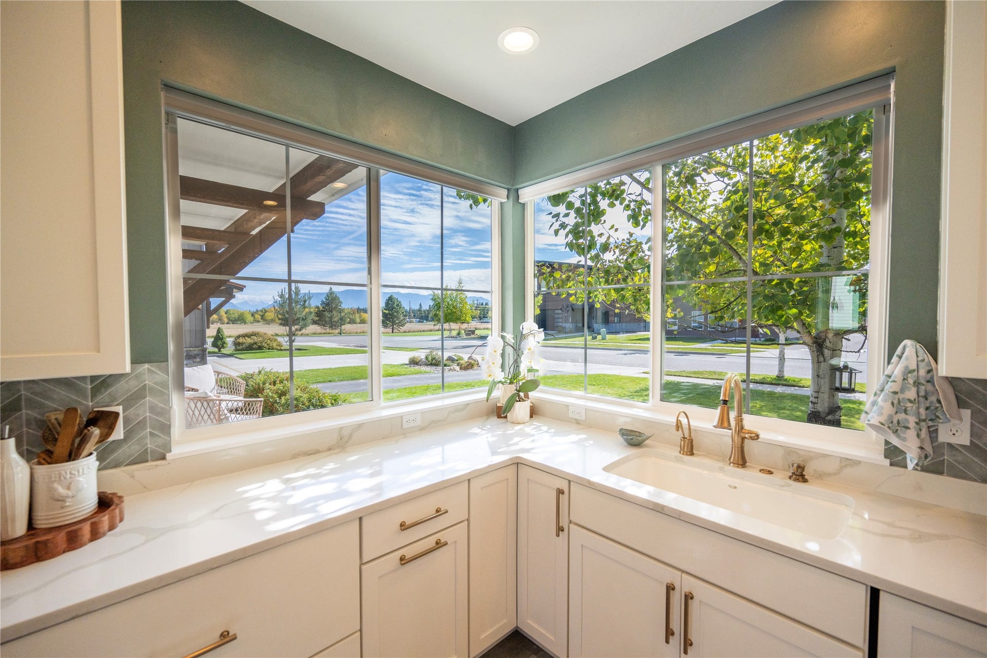 View from kitchen corner; cul-de-sac, open space, and Glacier Nat'l Park