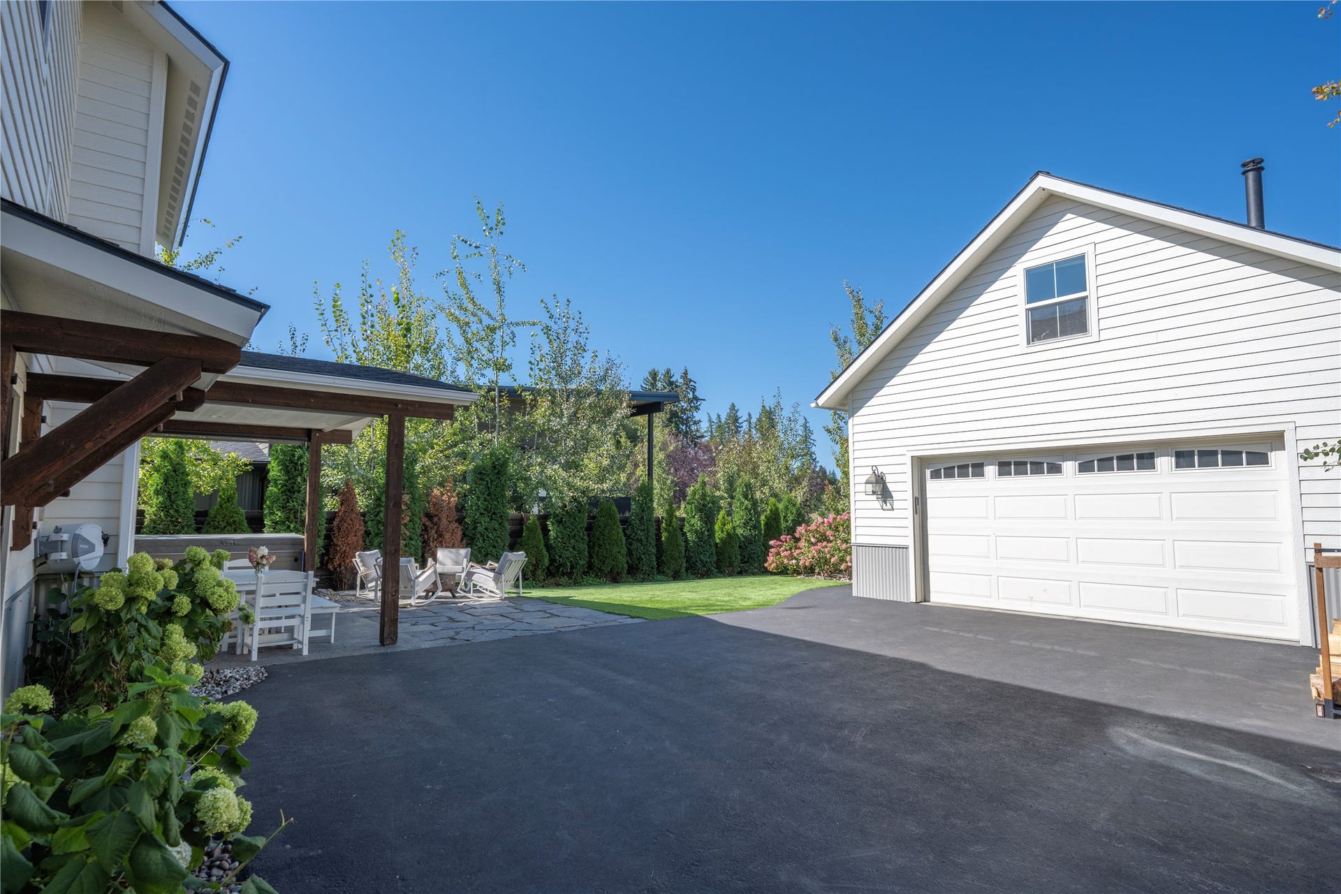 Showing back of home with detached, heated and insulated 2 car garage