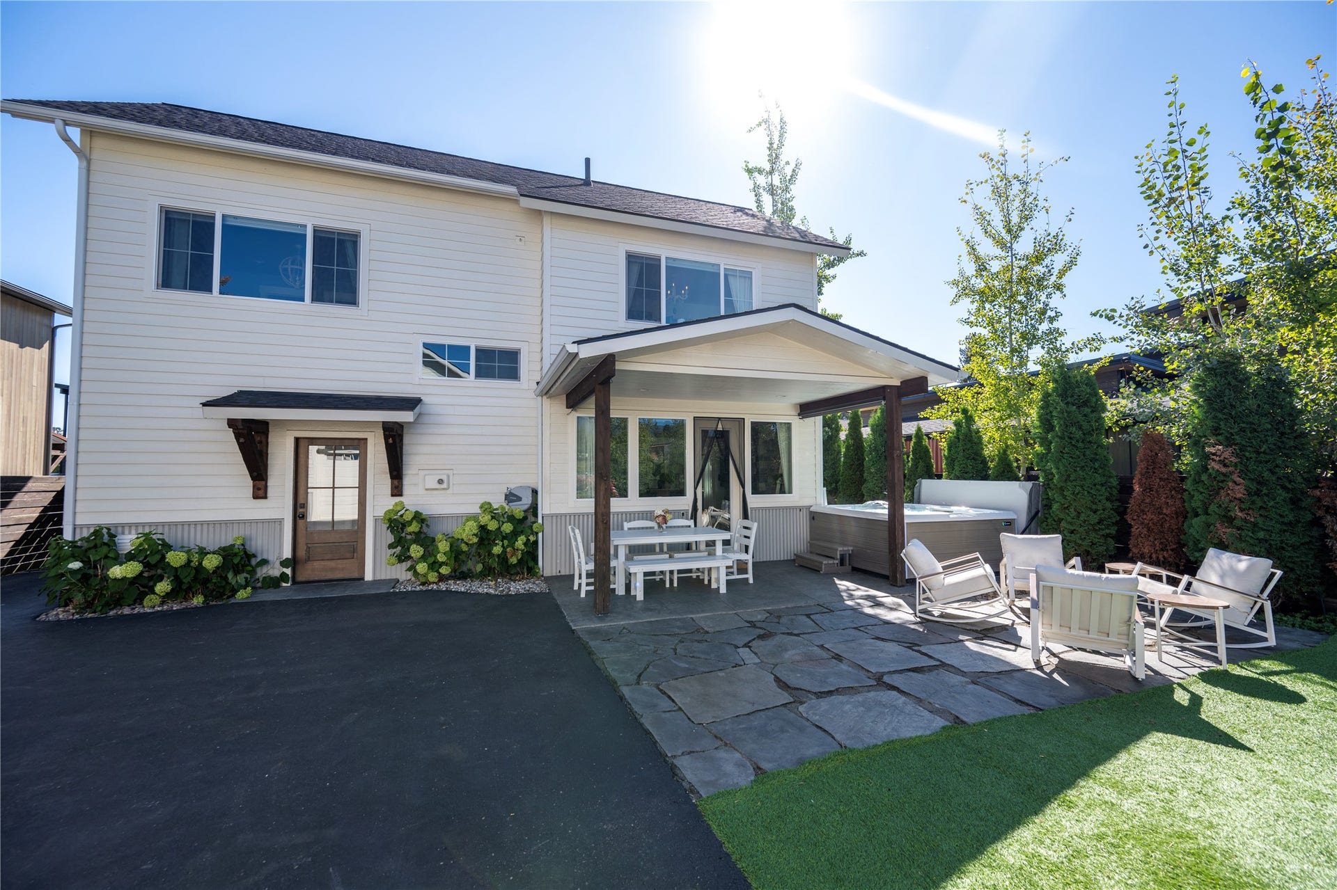 Back of home, covered eating area,  hot tub