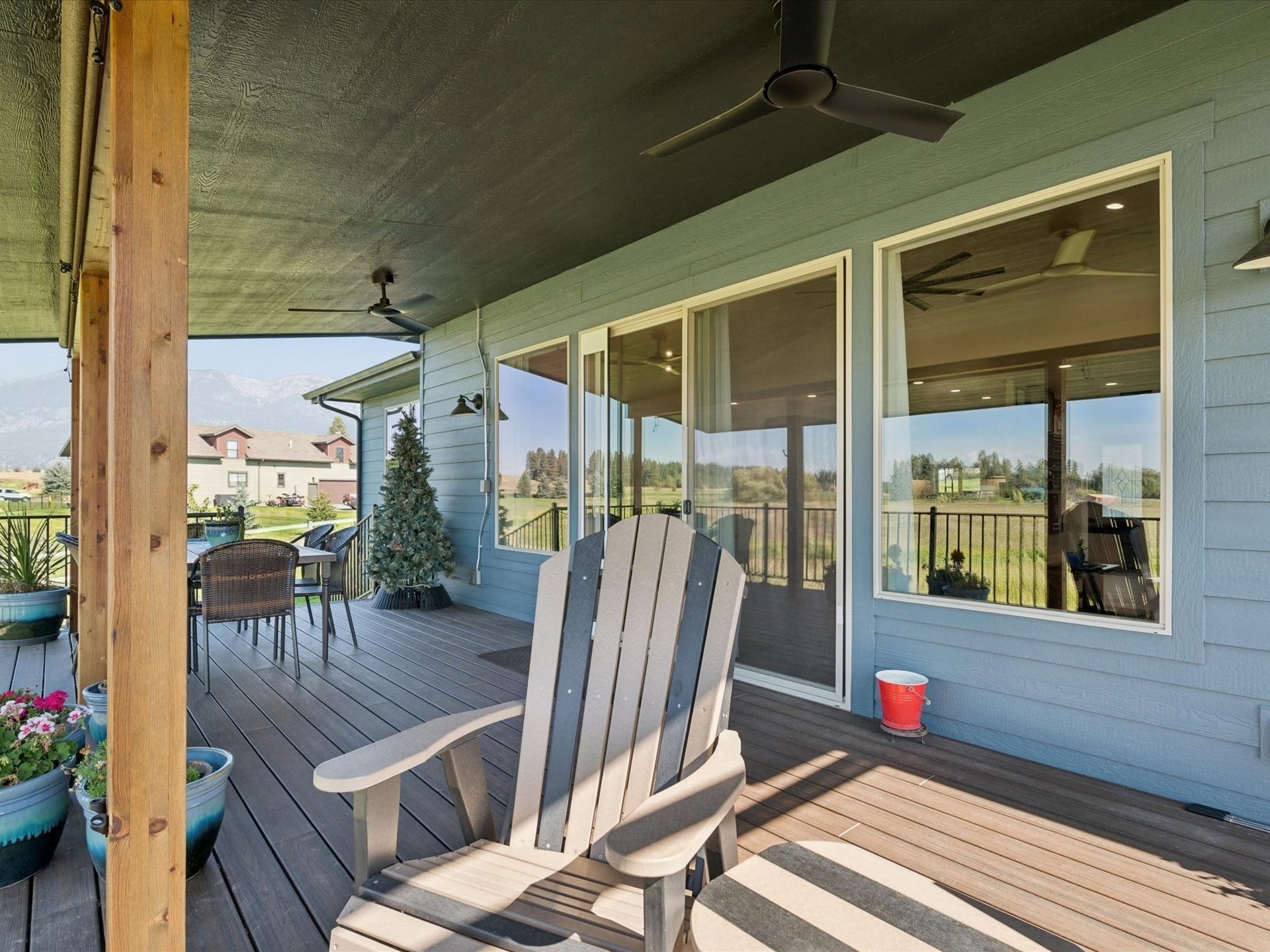 148 Fox Den Trail, Kalispell, MT 59901 Wood columns, ceiling fans, large glass windows, and a sliding glass door