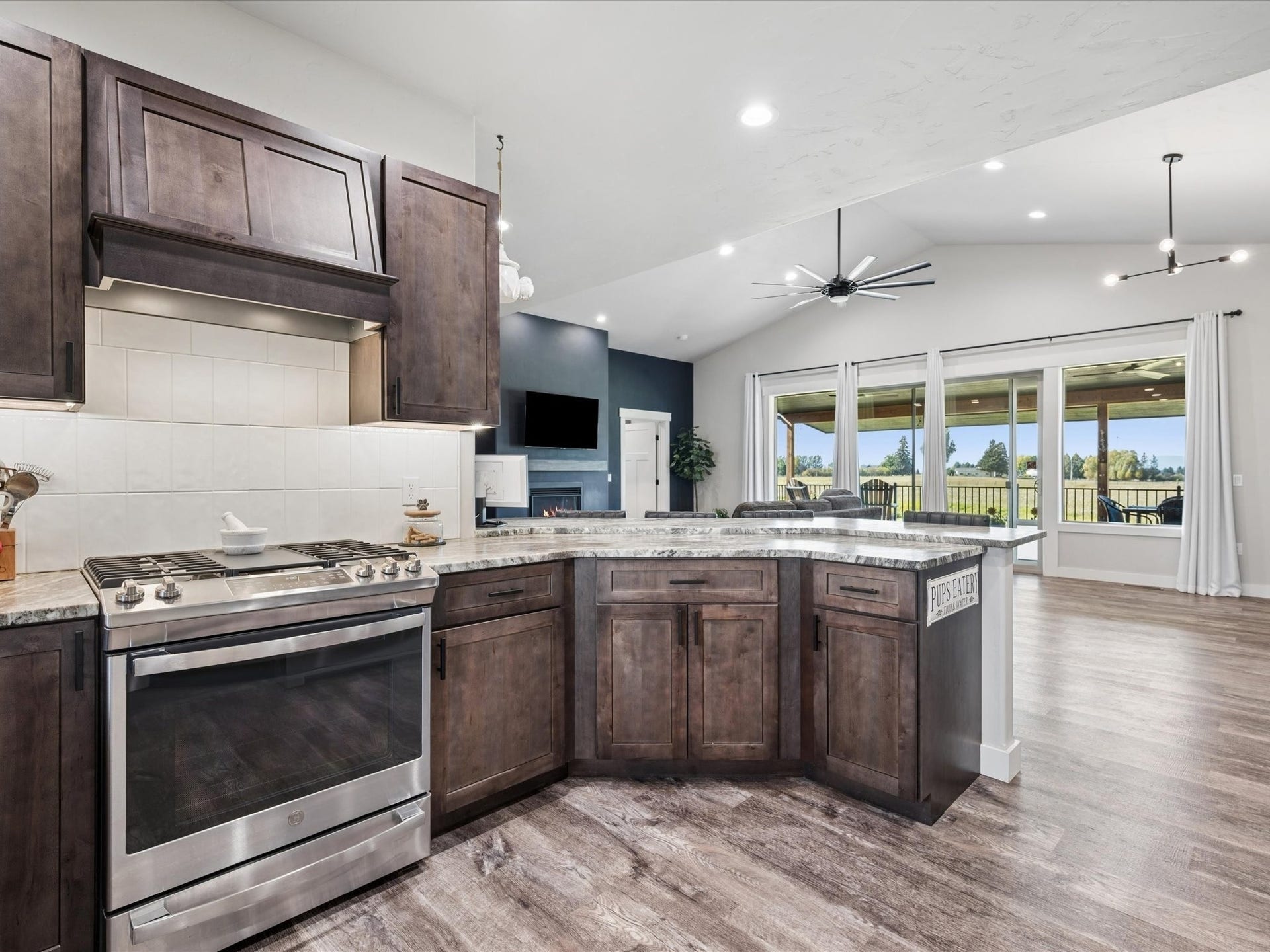 148 Fox Den Trail, Kalispell, MT 59901 Kitchen featuring a stainless steel appliances, dark wood-finish cabinetry, and granite countertops