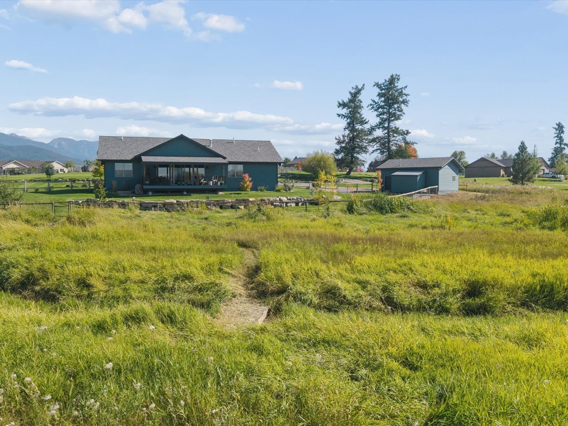 148 Fox Den Trail, Kalispell, MT 59901 Creek bridge over to the park land