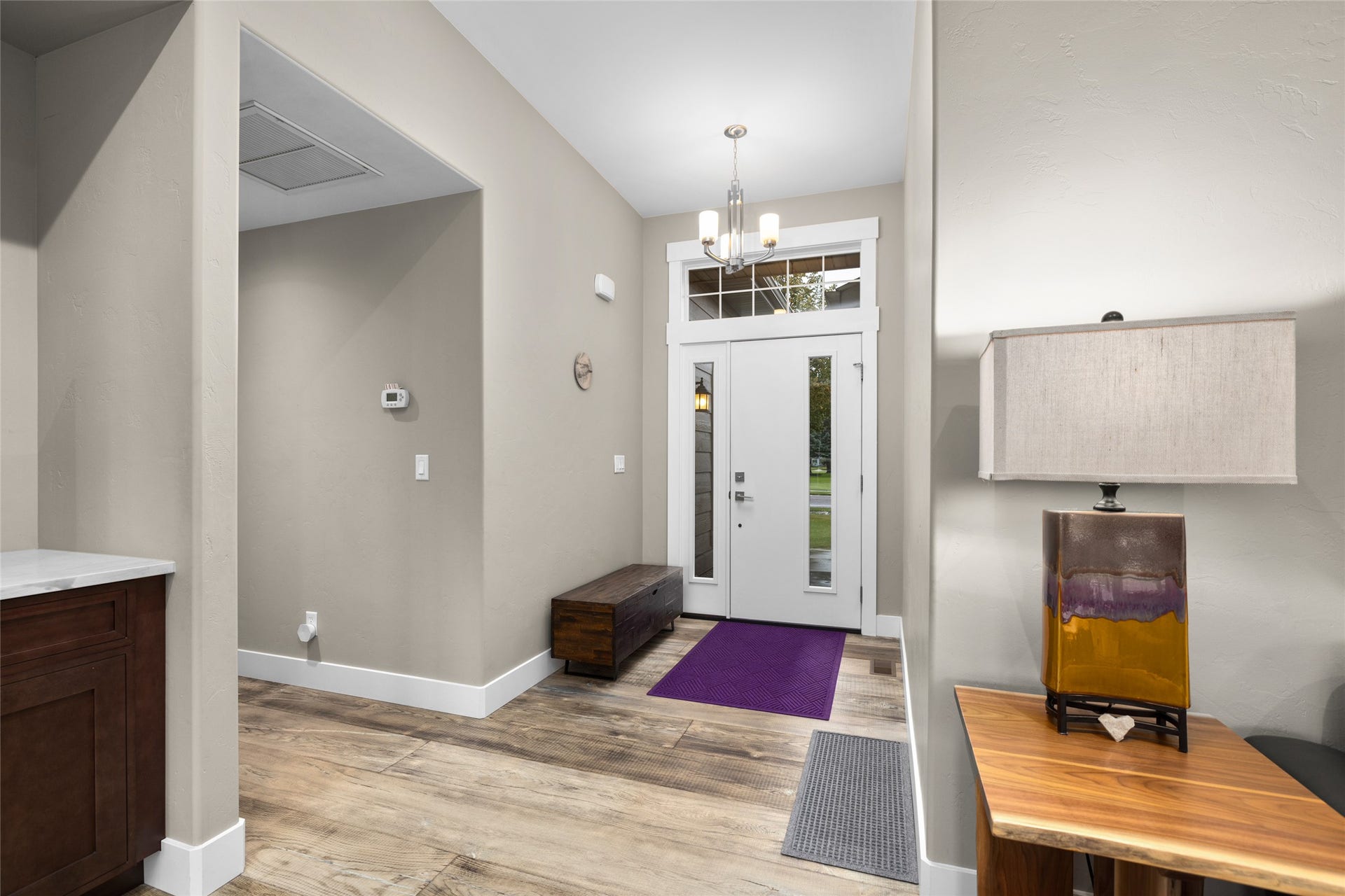 177 Palmer Drive, Kalispell, MT 59901 Entryway featuring a front door with integrated glass panels, a transom window, and a chandelier