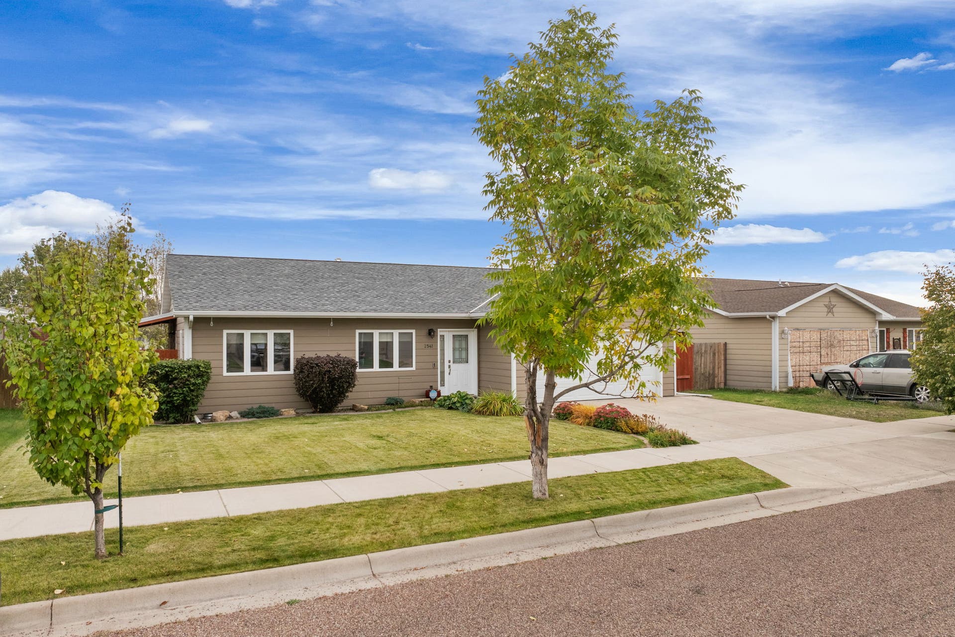 2541 Castle Pines Way, Great Falls, MT 59405 Single-story residence featuring siding exterior, a well-maintained lawn, and a concrete driveway