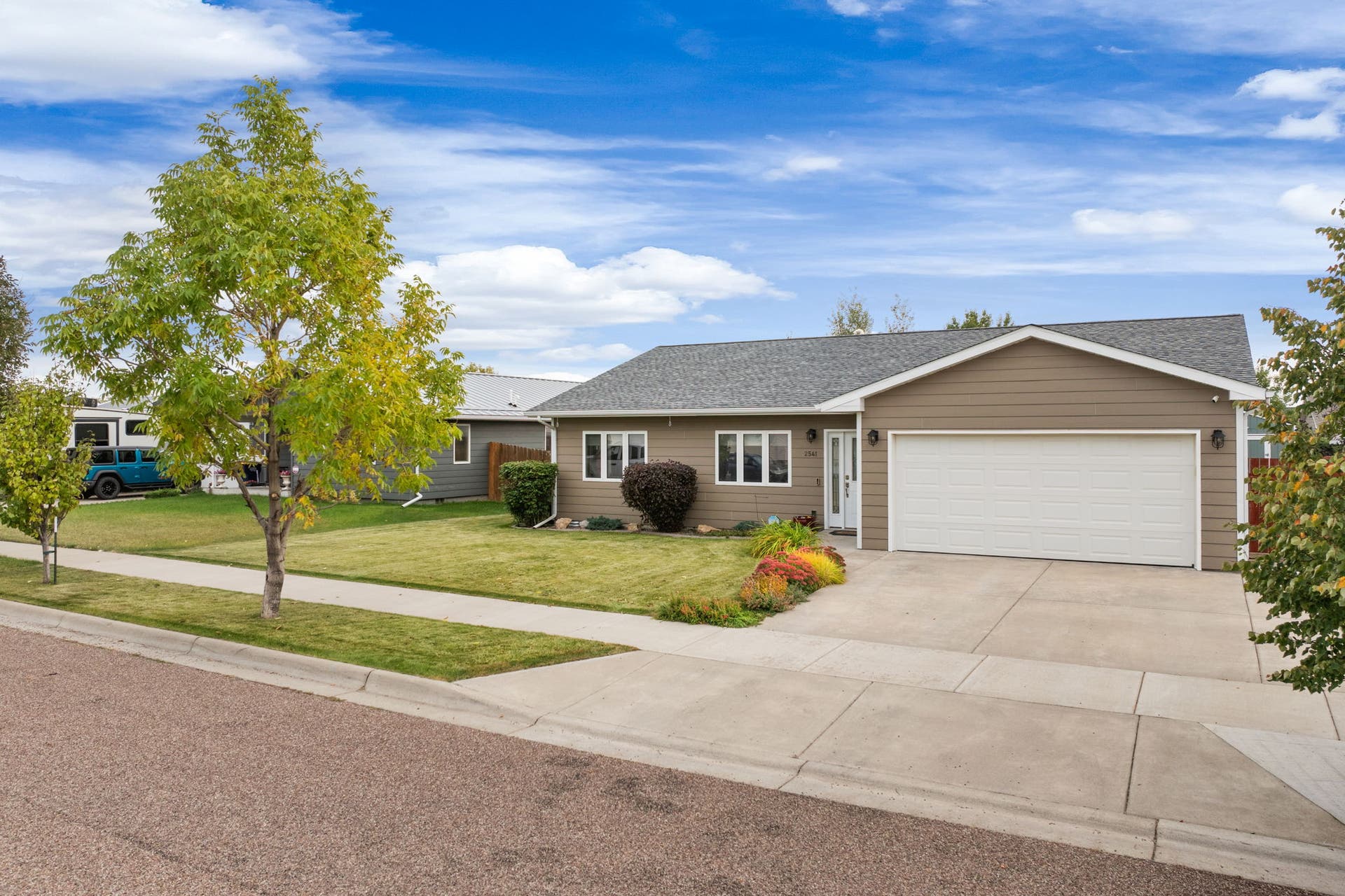 2541 Castle Pines Way, Great Falls, MT 59405 Light tan siding exterior with a dark gray shingle roof