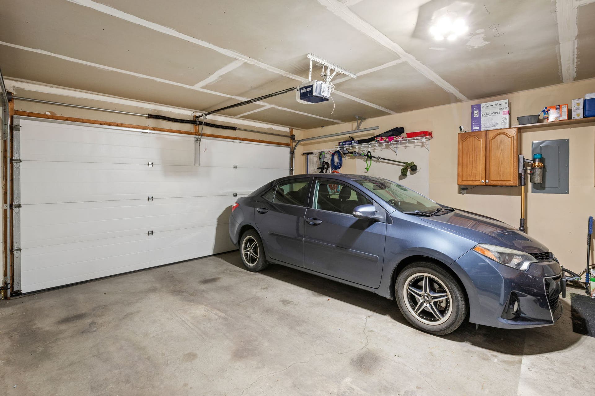 2541 Castle Pines Way, Great Falls, MT 59405 Attached two-car garage with an automatic door opener, concrete flooring, and built-in cabinetry
