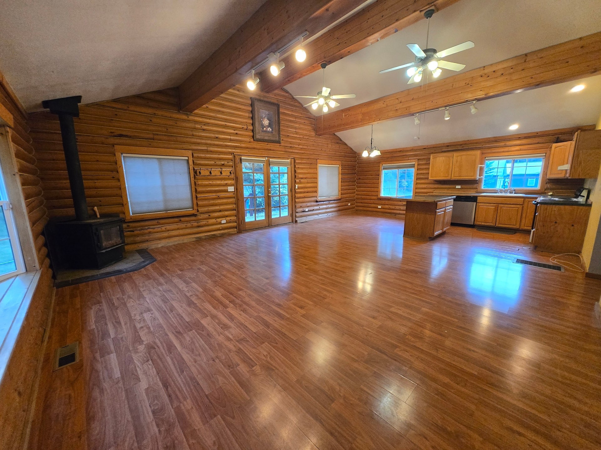 great room - living room, kitchen, dining area, French doors to side deck and detached garage