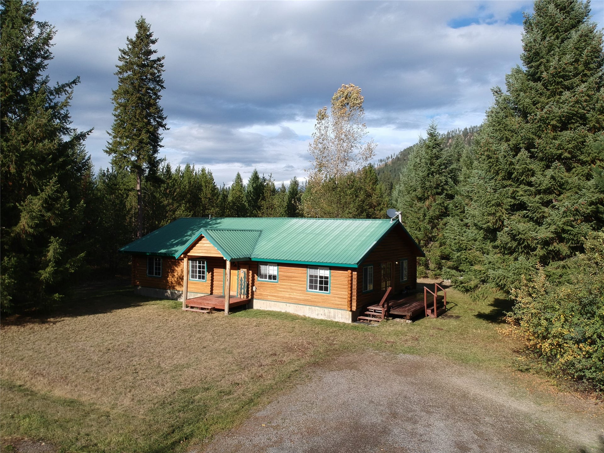 home with detached garage to the right of the picture