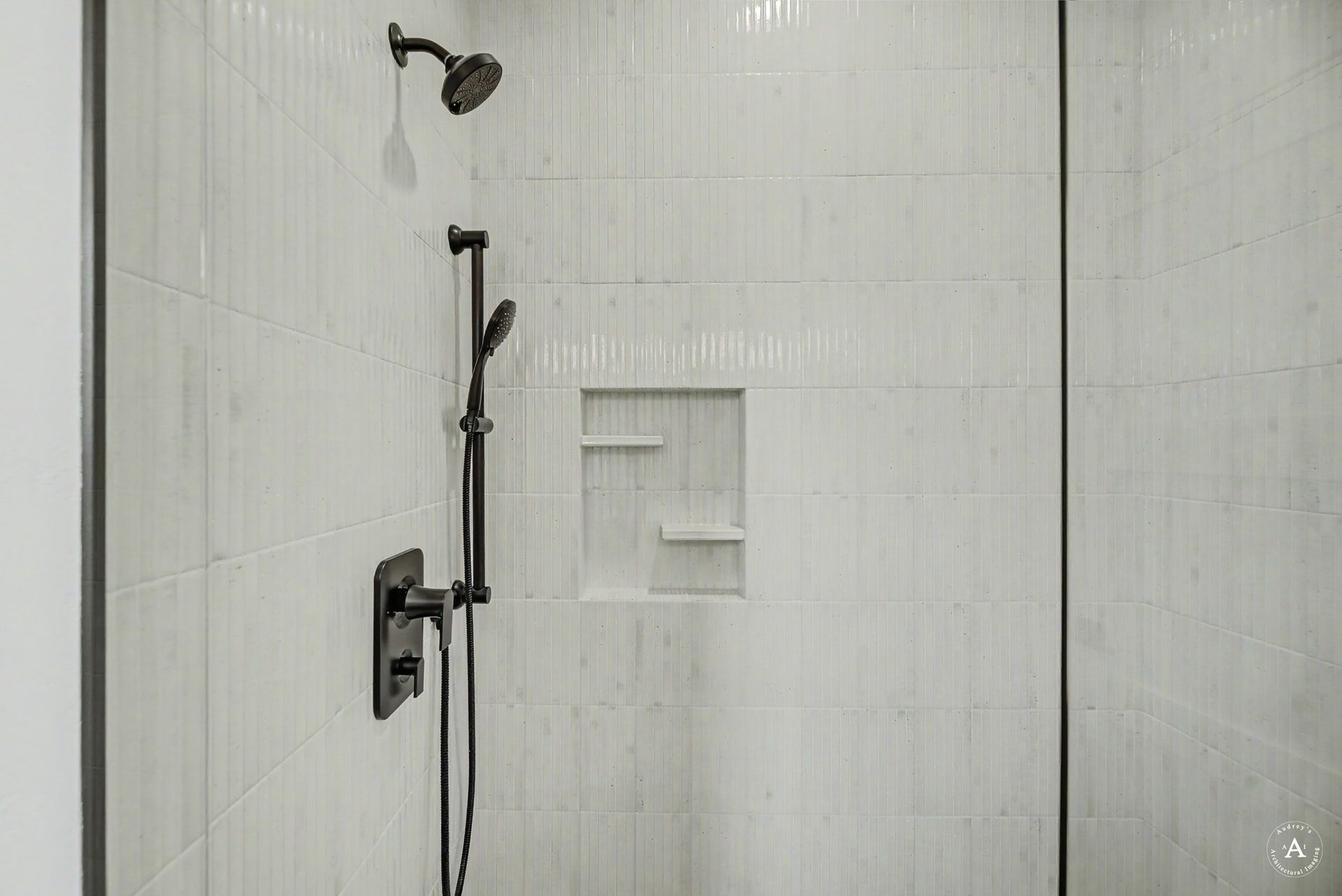 2754 Lone Chief Loop, Helena, MT 59601 Tiled shower with a rain shower head, handheld shower, and recessed shelving