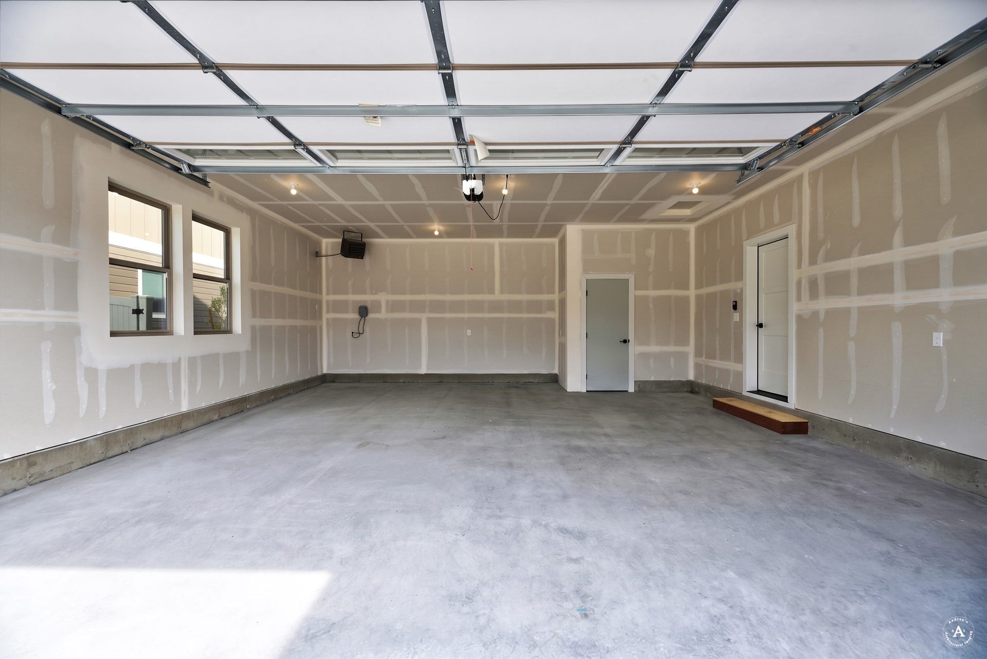 2754 Lone Chief Loop, Helena, MT 59601 Spacious garage with two windows, concrete flooring, overhead lighting, and two interior access doors