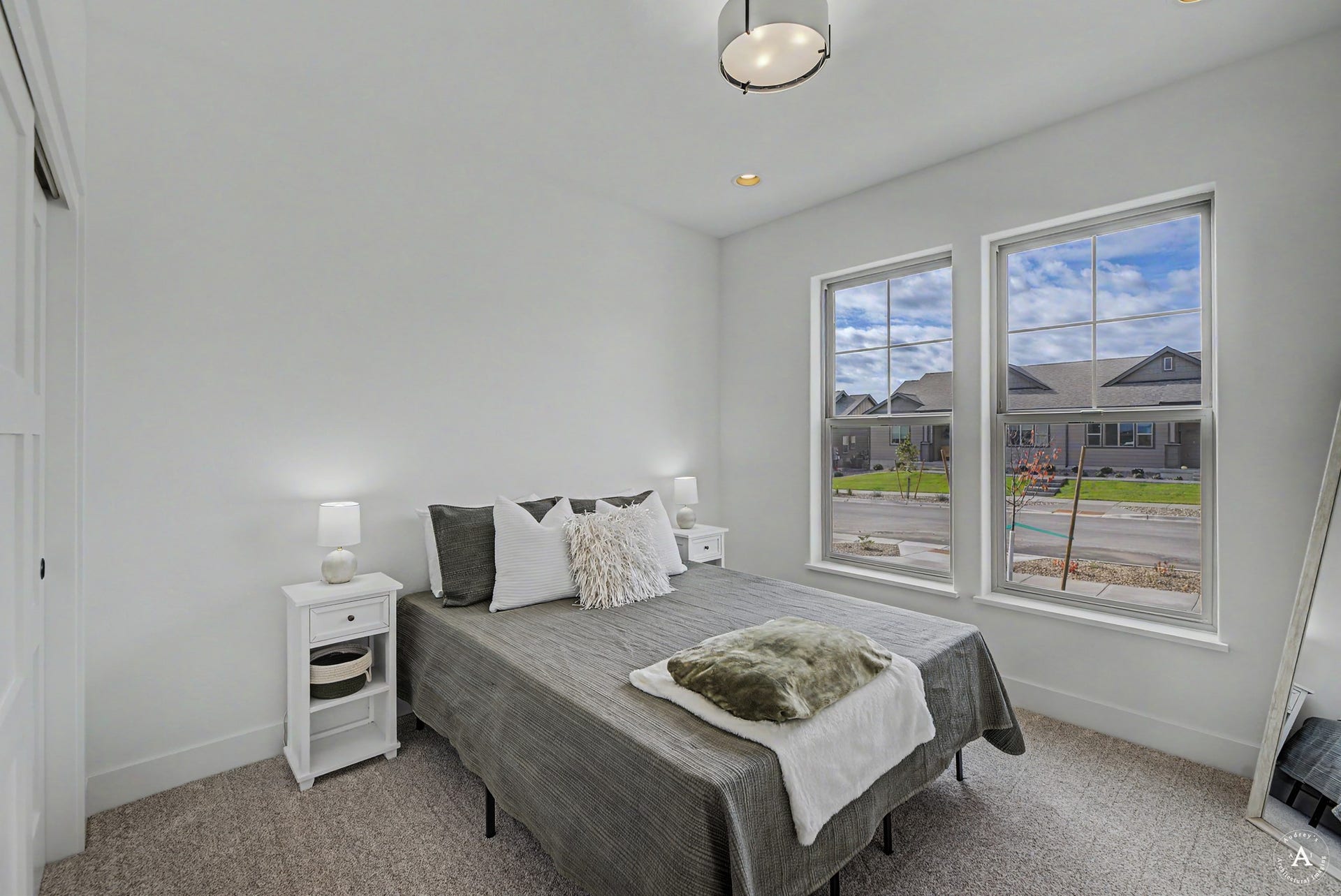 2754 Lone Chief Loop, Helena, MT 59601 Recessed ceiling lighting, a contemporary semi-flush mount fixture, two large windows, a sliding barn door, and neutral-toned carpeting