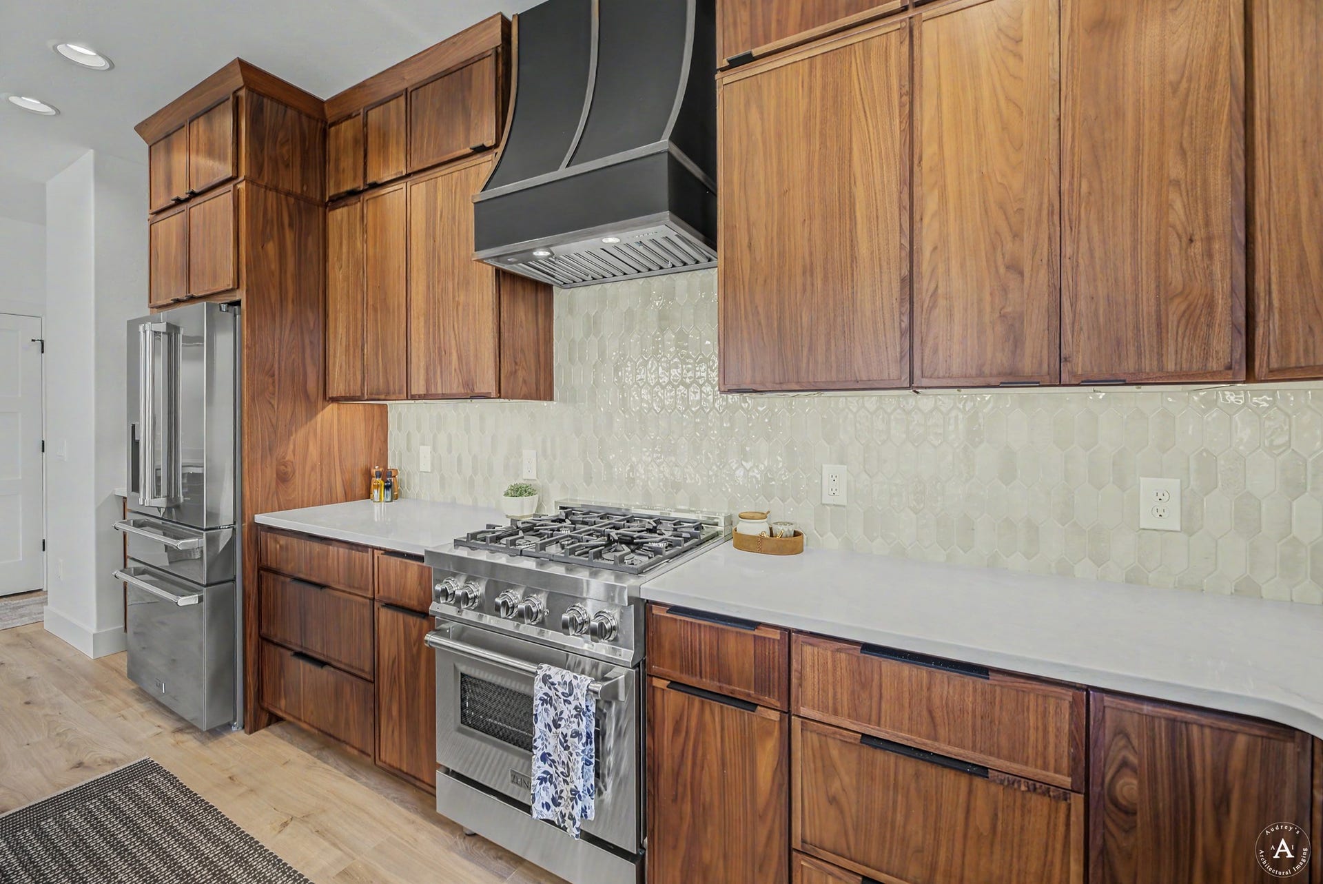 2754 Lone Chief Loop, Helena, MT 59601 Custom wood cabinetry, stainless steel appliances, white countertops, tile backsplash, and wood-finish flooring
