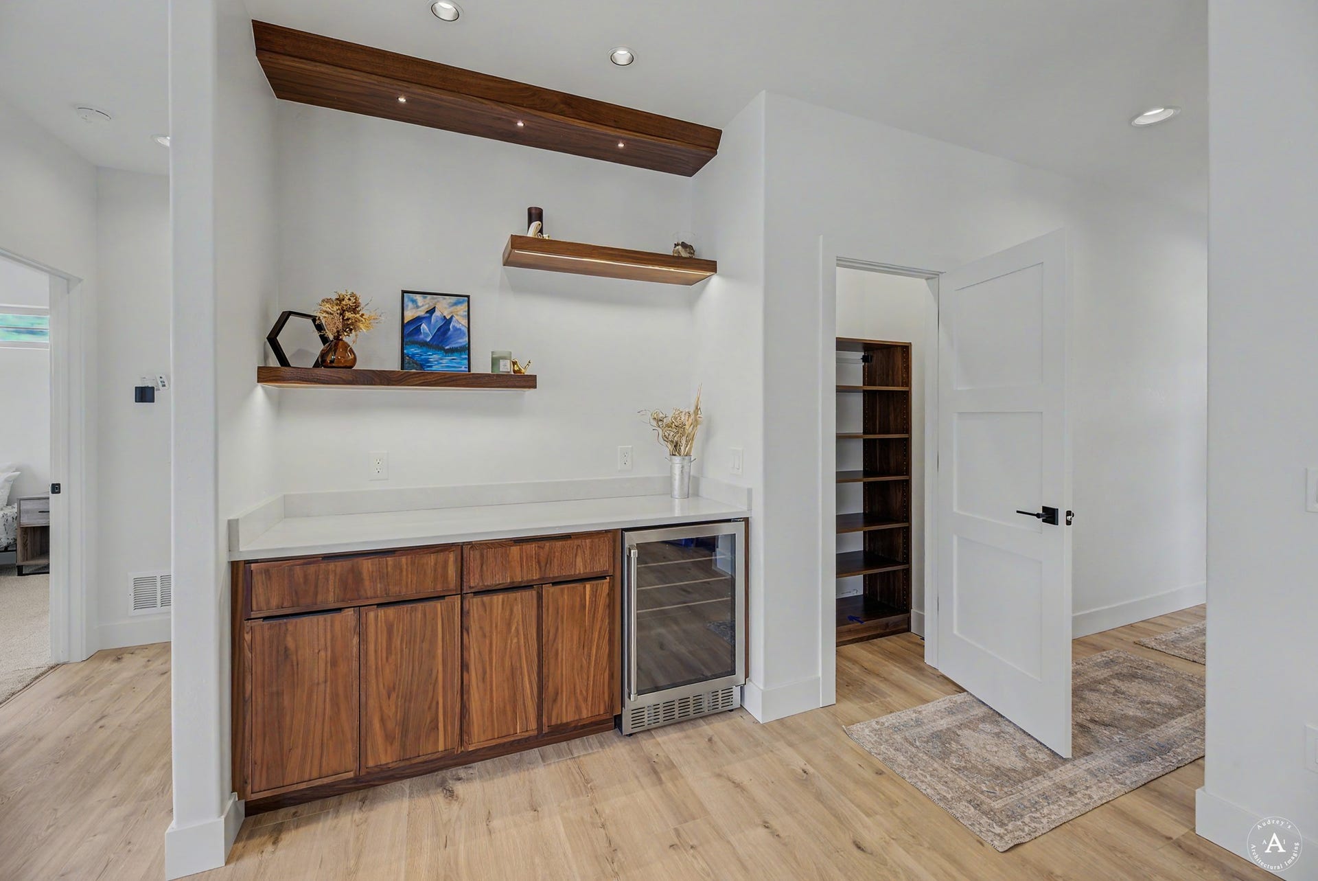 2754 Lone Chief Loop, Helena, MT 59601 Wood-finish flooring, built-in cabinetry with light-toned countertop, integrated beverage cooler, recessed lighting, and floating wood shelves
