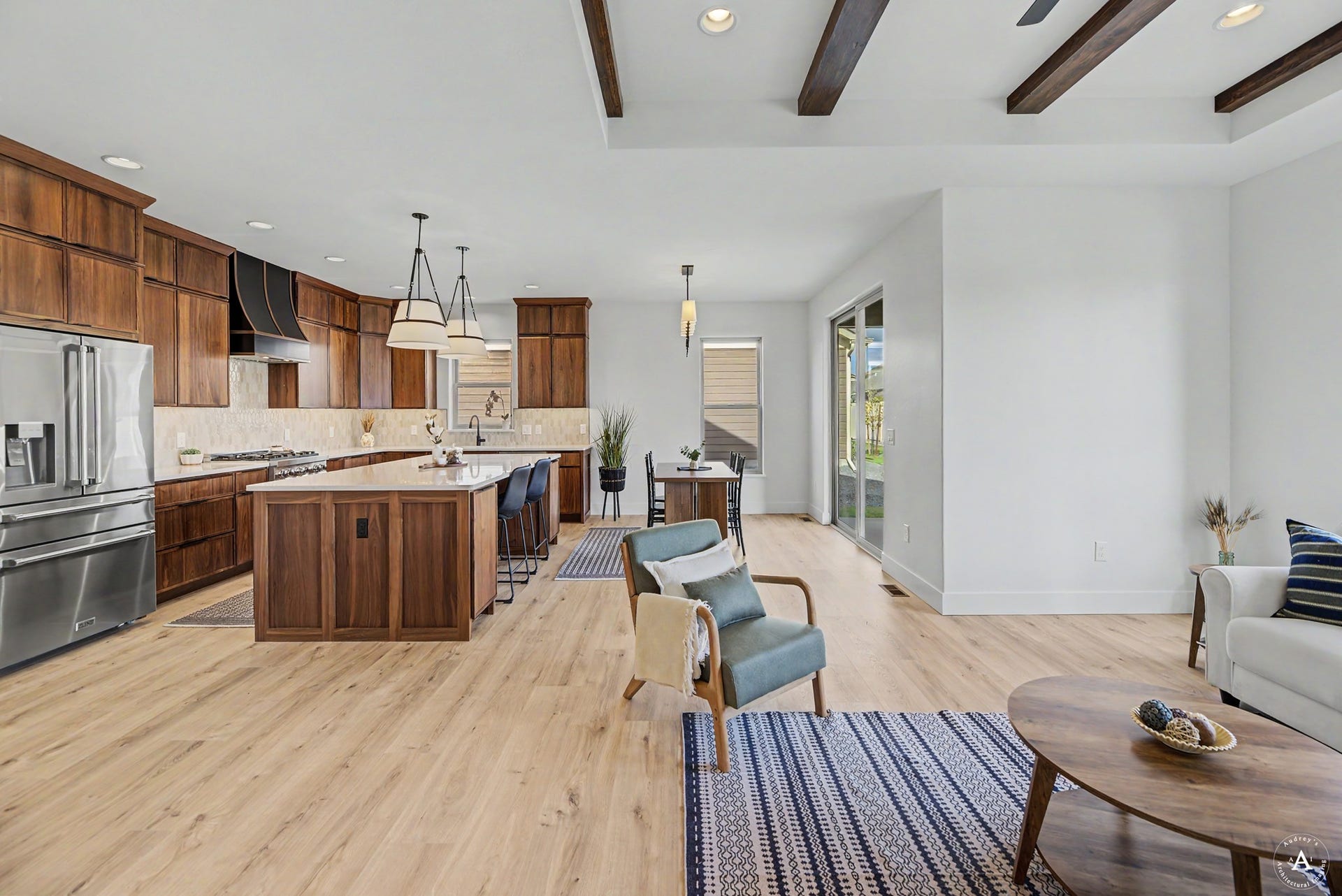 2754 Lone Chief Loop, Helena, MT 59601 Open-concept living space with wood-finish flooring, exposed ceiling beams, and a sliding glass door