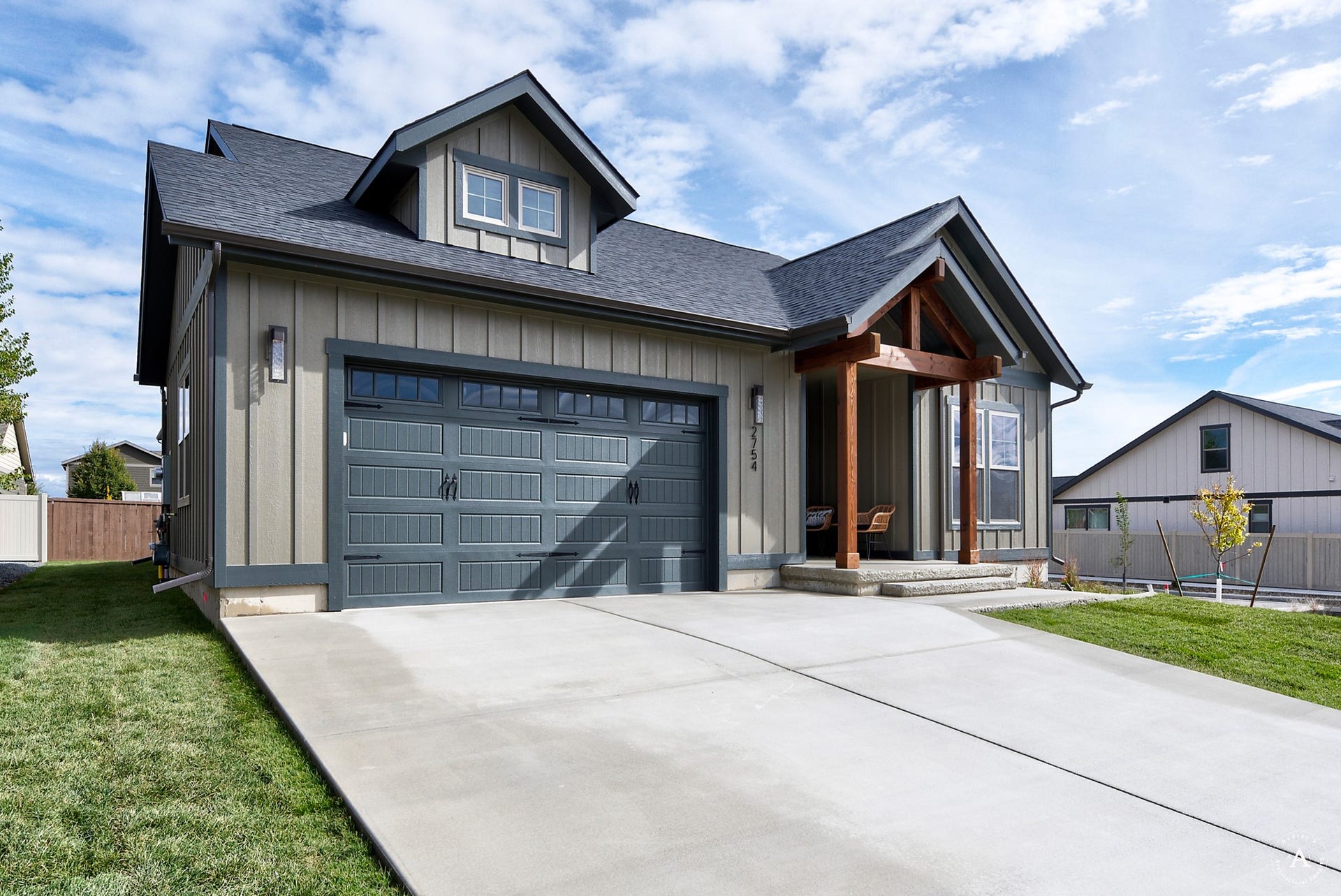 2754 Lone Chief Loop, Helena, MT 59601 Contemporary exterior with a two-car garage, dormer window, and covered entry with wood-beam accents