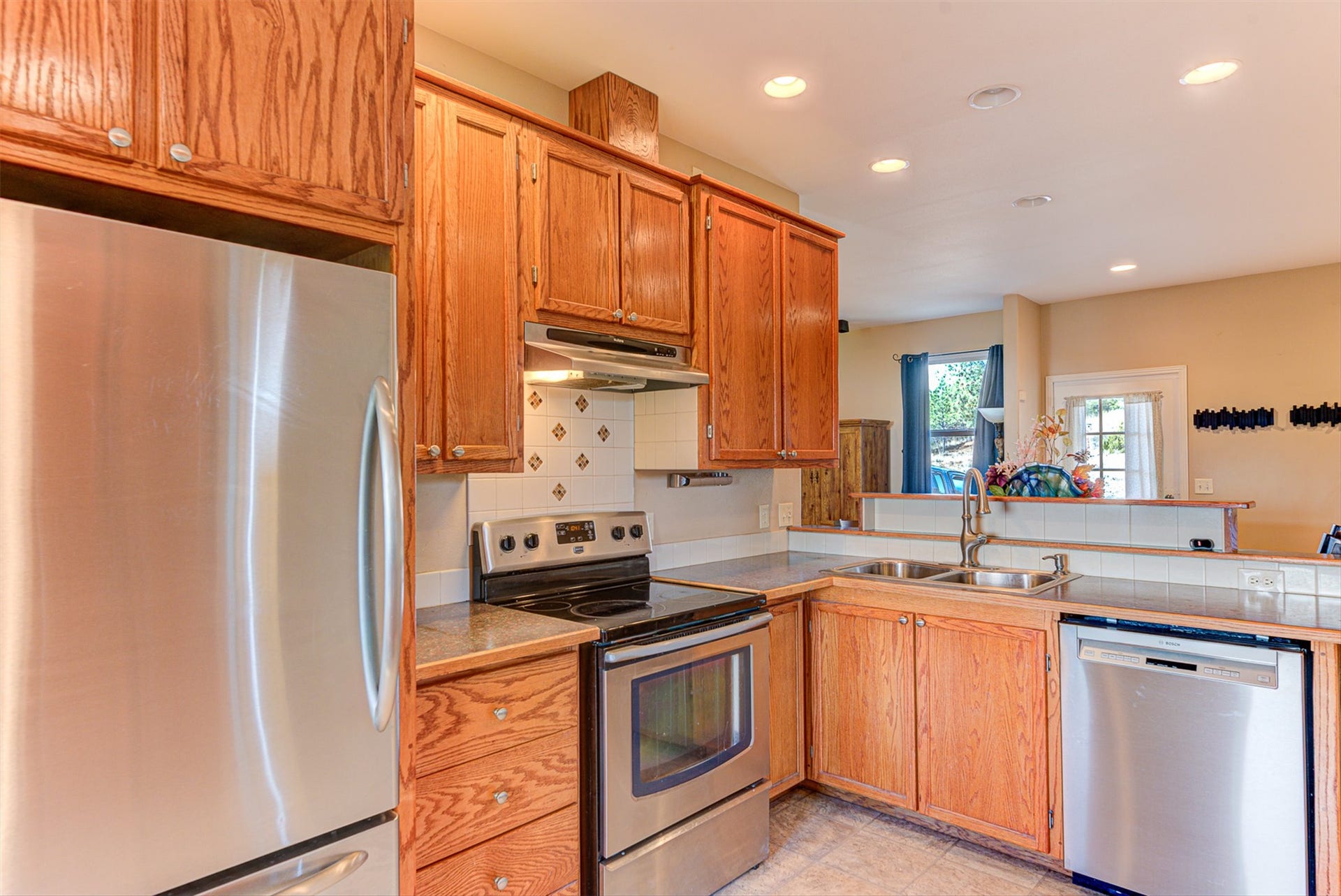 8224 Hillside Drive, Helena, MT 59602 Kitchen featuring wood cabinetry, stainless steel appliances, a dual basin sink, and recessed lighting