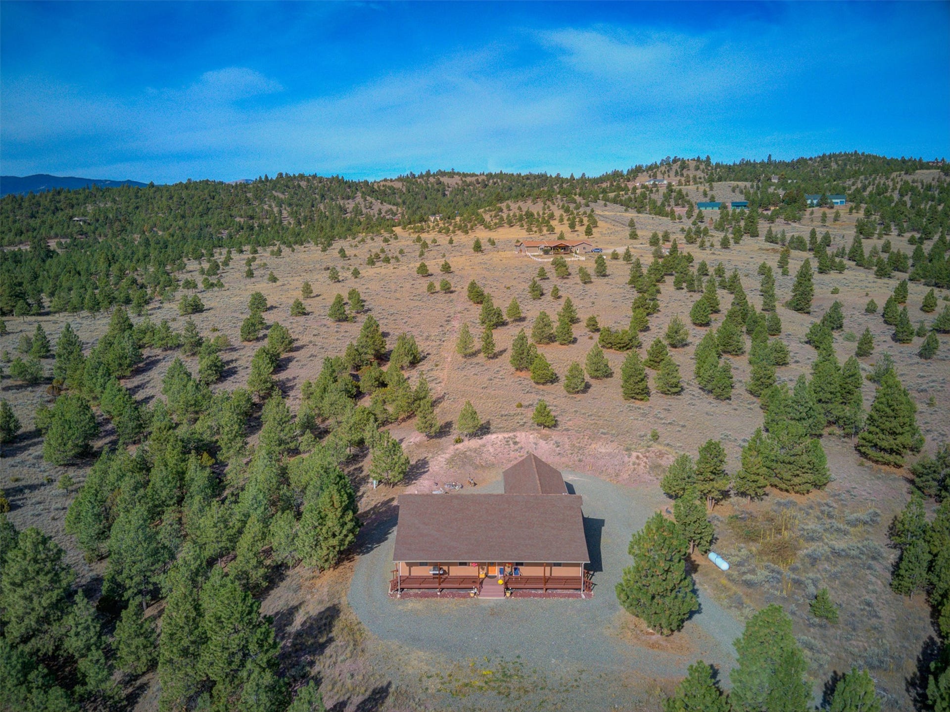 8224 Hillside Drive, Helena, MT 59602 Expansive acreage with a single-story residence featuring a covered front porch and a detached structure