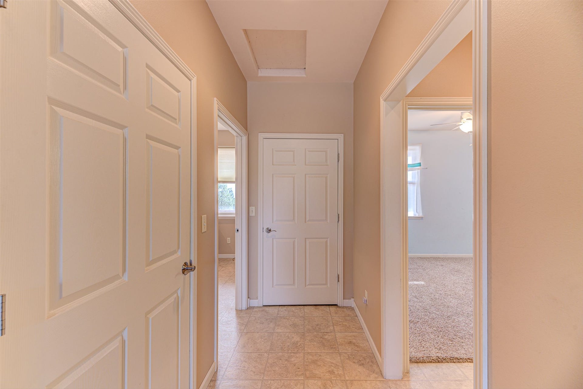 8224 Hillside Drive, Helena, MT 59602 Hallway featuring tile flooring, neutral wall tones, white panel doors, and recessed ceiling access